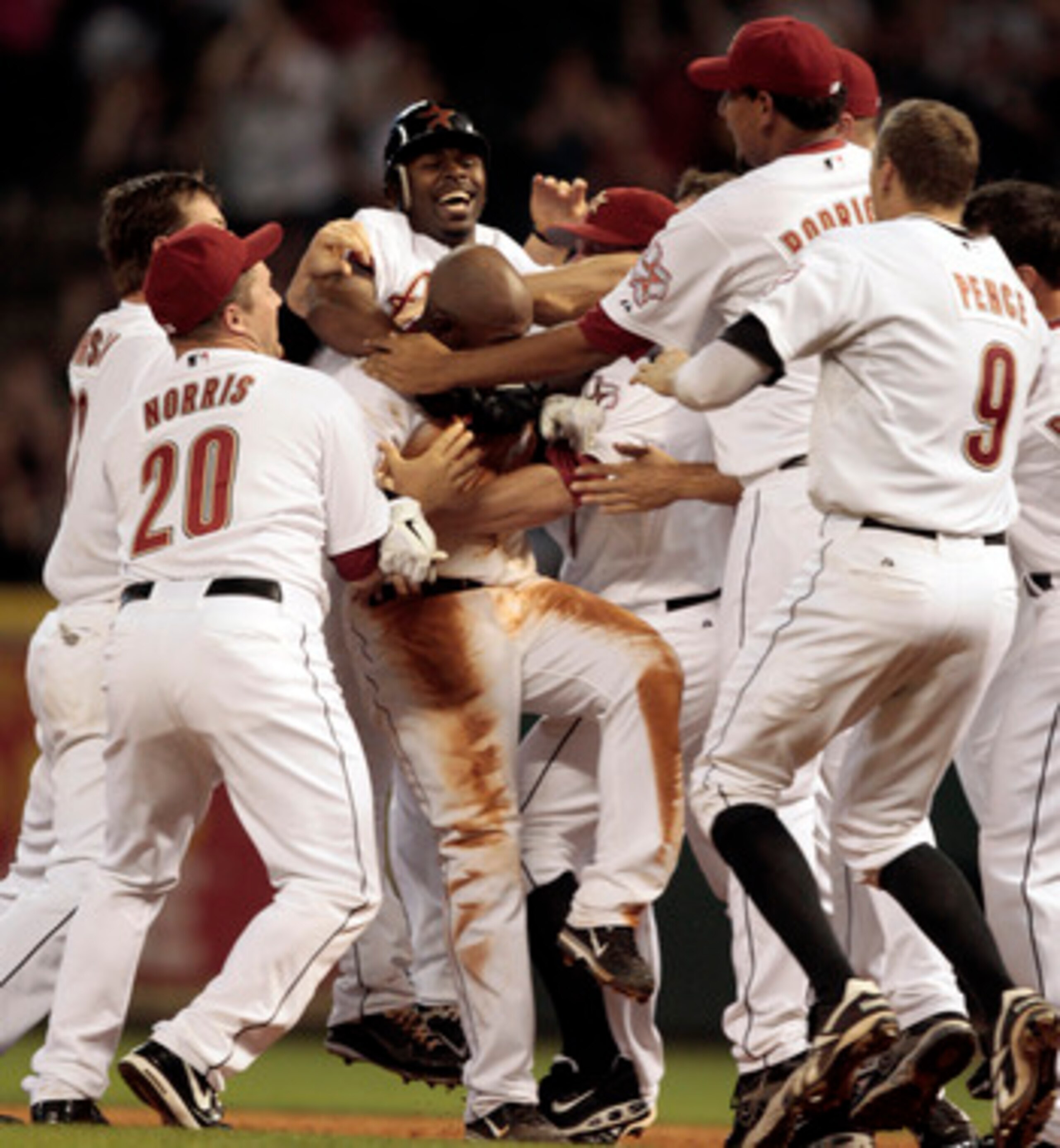 HOUSTON - APRIL 30: Jason Bourgeois #11, center, is mobbed by Michael Bourn #21, Bud Norris #20 and Aneury Rodriguez #62 after hitting a walkoff single in the ninth to score Bill Hall from second base with the winning run against the Milwaukee Brewers at