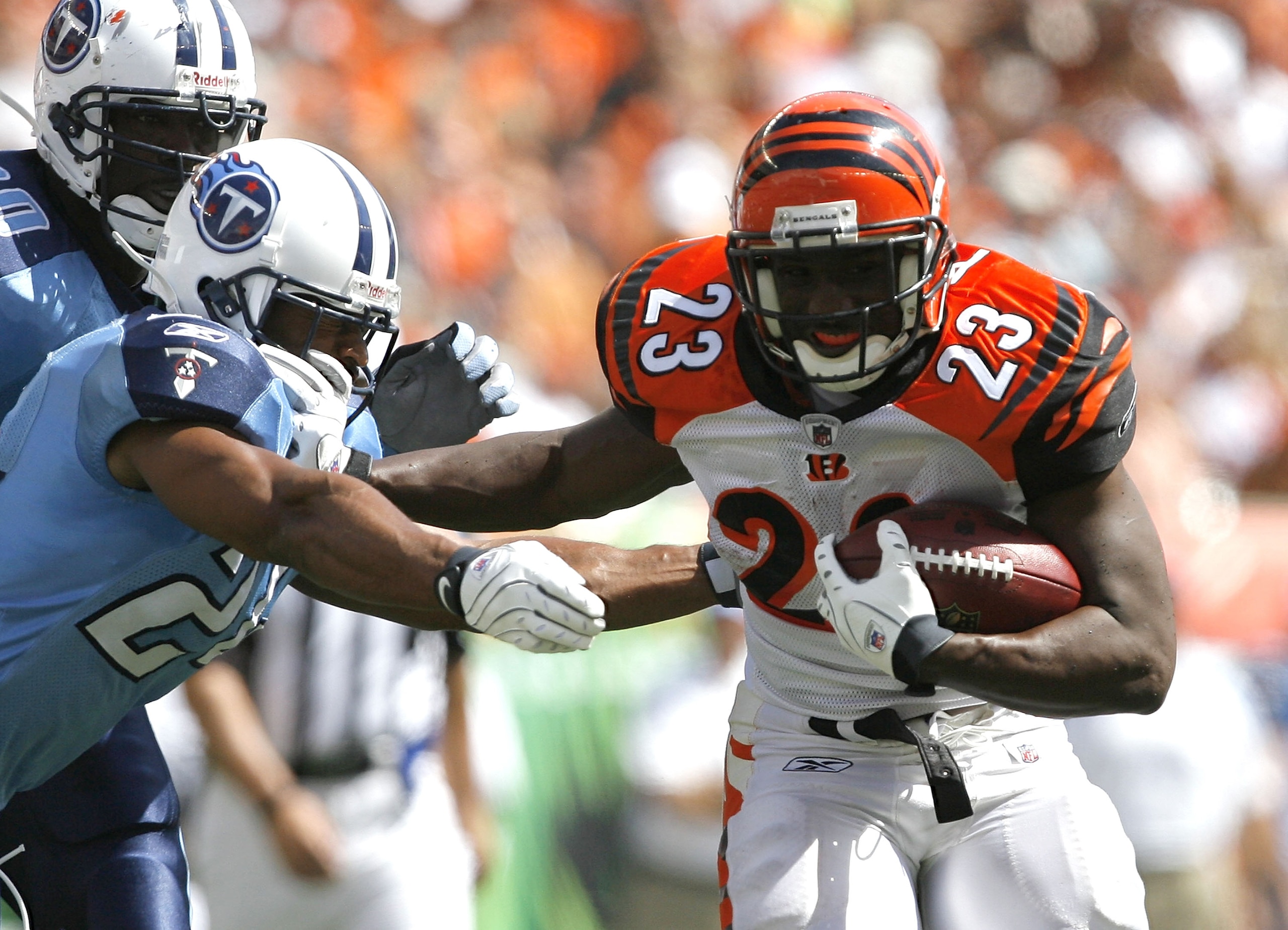 CINCINNATI - SEPTEMBER 14: Chris Perry #23 of the Cincinnati Bengals runs by Chris Hope #24 of the Tennessee Titans during the second quarter of their NFL game September 14, 2008 at Paul Brown Stadium in Cincinnati, Ohio. The Titans defeated the Bengals 2