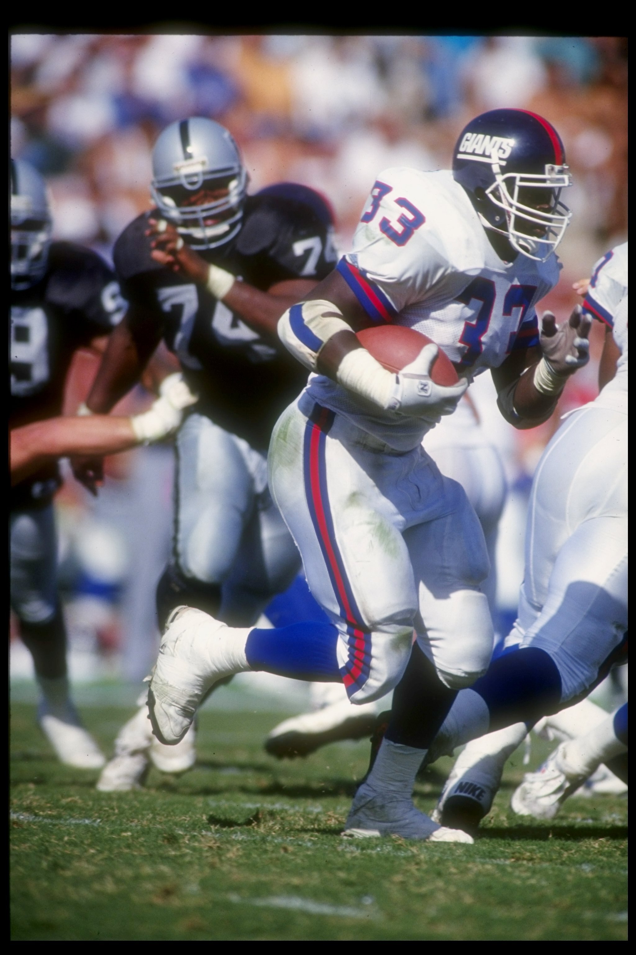 4 Sep 1992:  Running back Jarrod Bunch of the New York Giants moves the ball during a game against the Los Angeles Raiders at the Los Angeles Memorial Coliseum in Los Angeles, California.  The Raiders won the game, 13-10. Mandatory Credit: Stephen Dunn  /