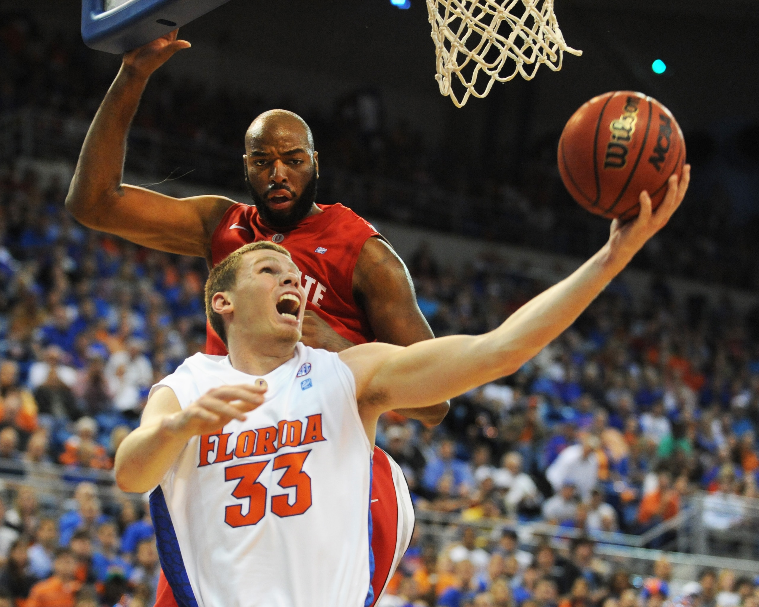 GAINESVILLE, FL - NOVEMBER 16: Erik Murphy #33 of the Florida Gators scores under the basket against Dallas Lauderdale #52 of Ohio State Buckeyes during the game on November 16, 2010 at the Stephen C. O'Connell Center in Gainesville, Florida.  (Photo by A