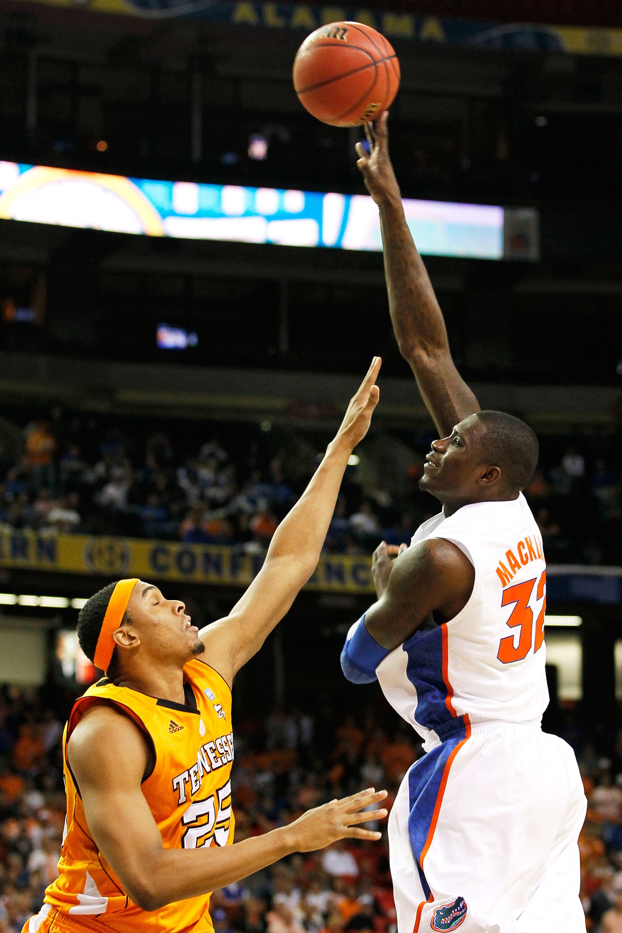 ATLANTA, GA - MARCH 11:  Vernon Macklin #32 of the Florida Gators shoots over John Fields #25 of the Tennessee Volunteers during the quarterfinals of the SEC Men's Basketball Tournament at Georgia Dome on March 11, 2011 in Atlanta, Georgia.  (Photo by Kev