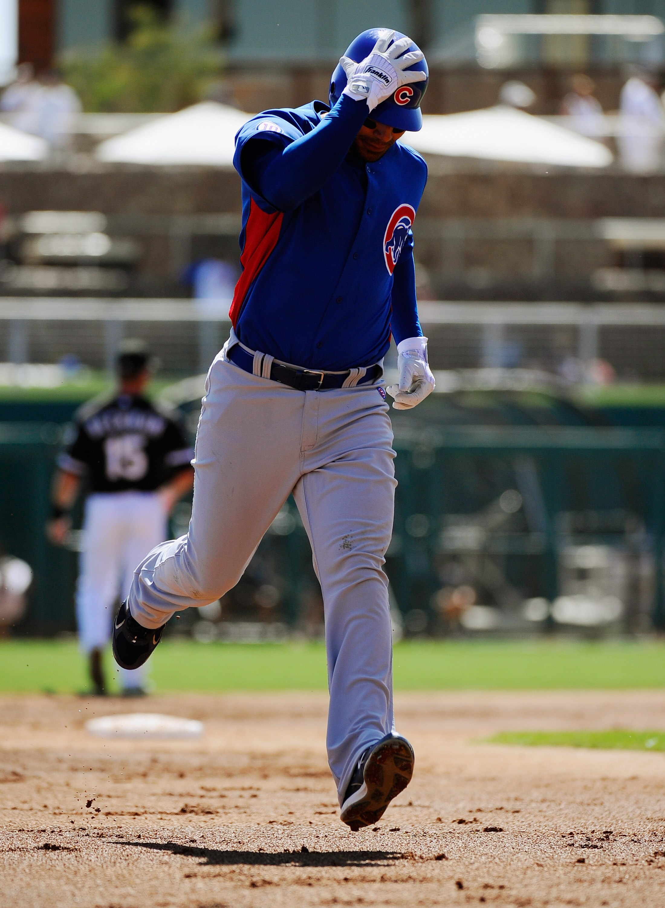 GLENDALE, AZ - MARCH 11:  Carlos Pena #22 of the Chicago Cubs circle the bases aftet a hitting a one run home run against the Chicago White Sox during the second inning of the spring training baseball game at Camelback Ranch on March 11, 2011 in Glendale,