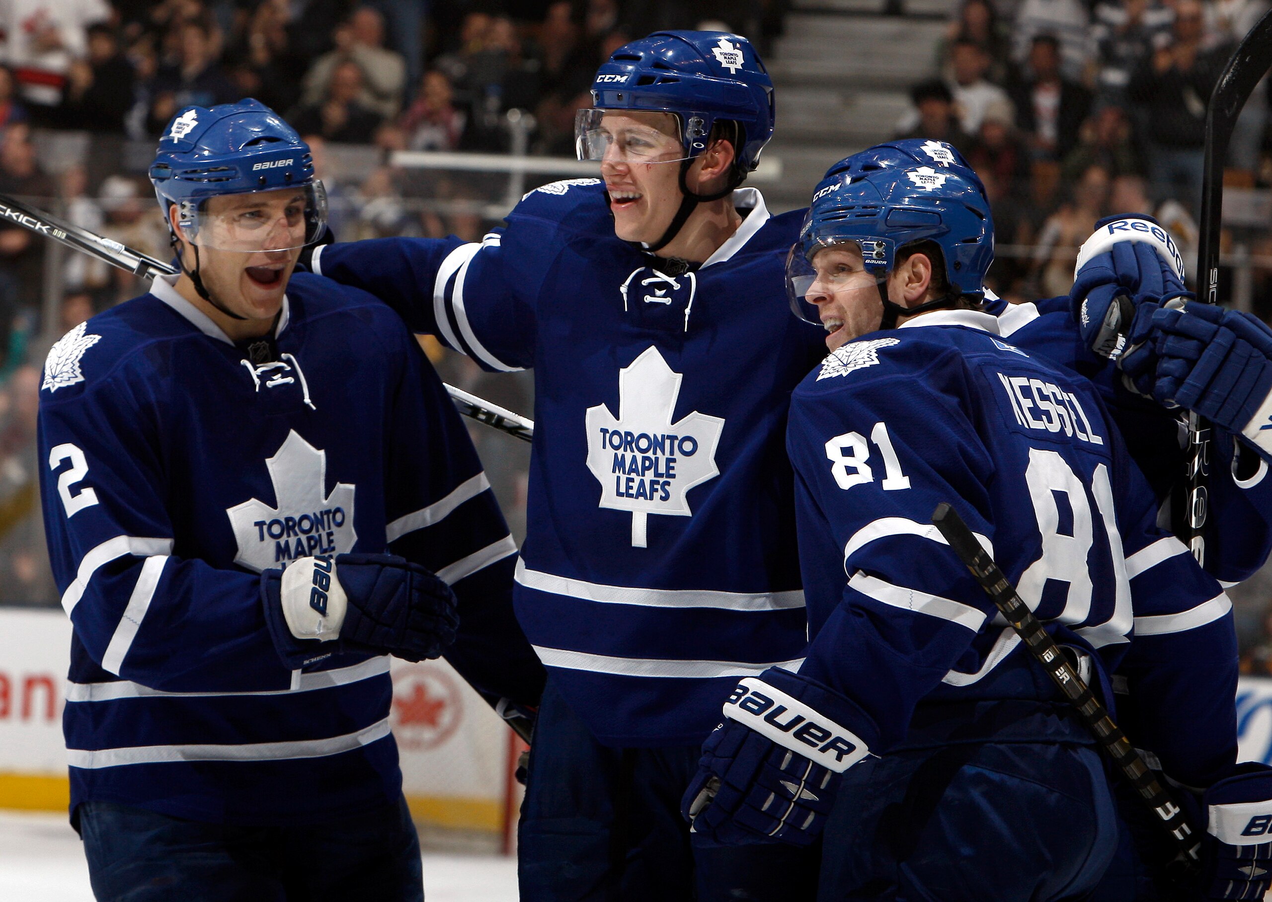 TORONTO, CANADA - MARCH 19  Luke Schenn #2, Keith Aulie #59 and Phil Kessel #81 of the Toronto Maple Leafs celebrate Keith Aulie goal against the Boston Bruins during game action at the Air Canada Centre March 19, 2011 in Toronto, Ontario, Canada. (Photo
