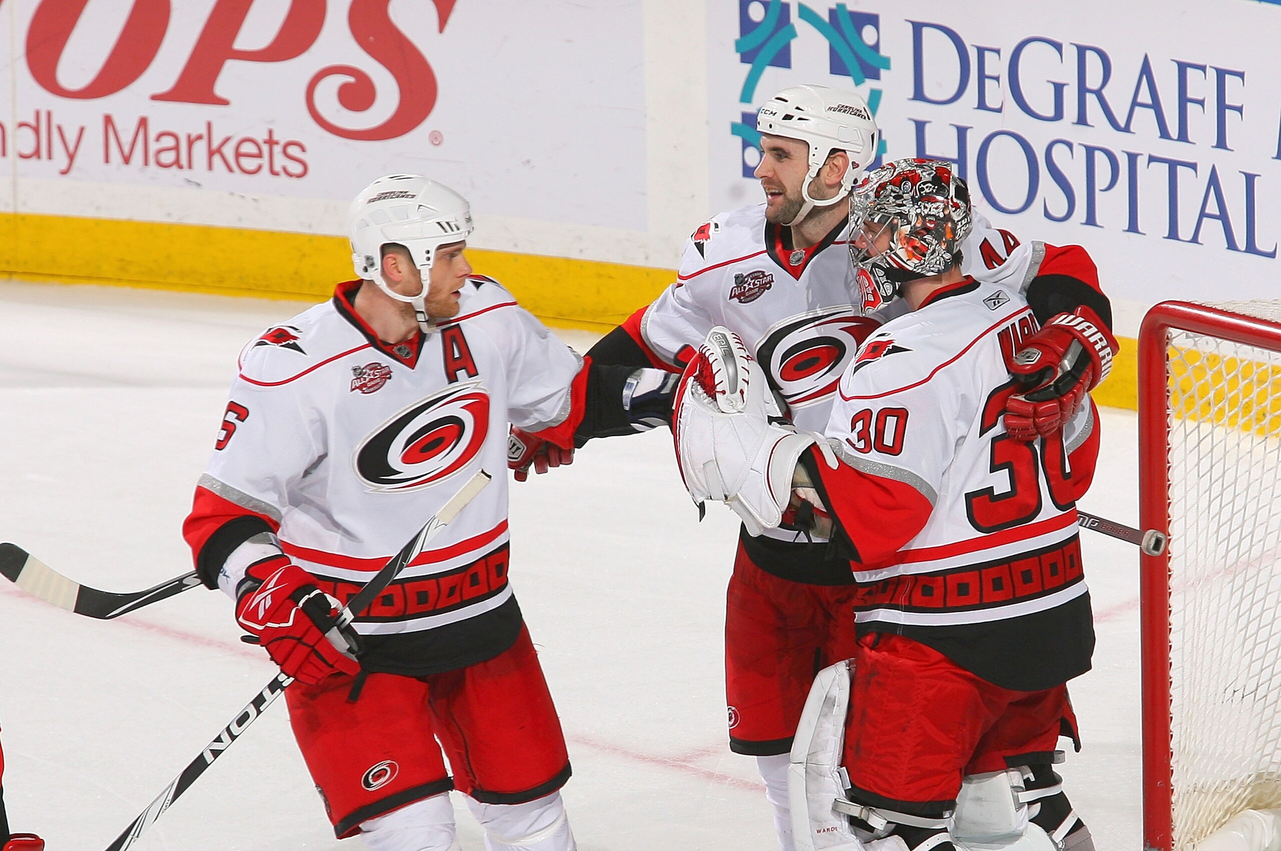 BUFFALO, NY - MARCH 15: Tim Gleason #6, Jay Harrison #44 and Cam Ward #30  of the Carolina Hurricanes celebrate after defeating the Buffalo Sabres  at HSBC Arena on March 15, 2011 in Buffalo, New York. Carolina won 1-0. (Photo by Rick Stewart/Getty Images