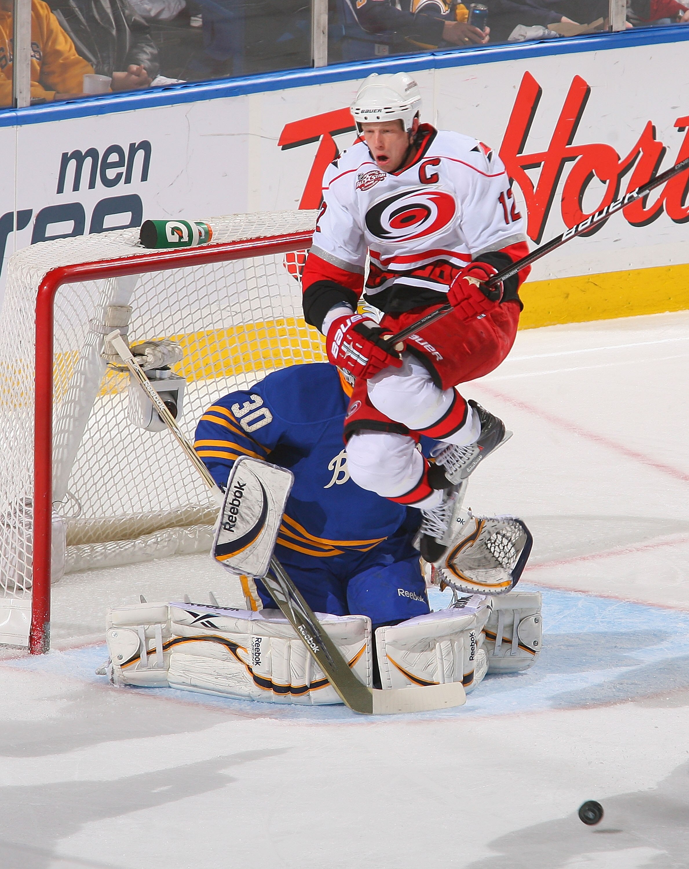 BUFFALO, NY - MARCH 15: Eric Staal #12 of the the Carolina Hurricanes jumps in front of Ryan Miller #30 of Buffalo Sabres  at HSBC Arena on March 15, 2011 in Buffalo, New York.  (Photo by Rick Stewart/Getty Images)