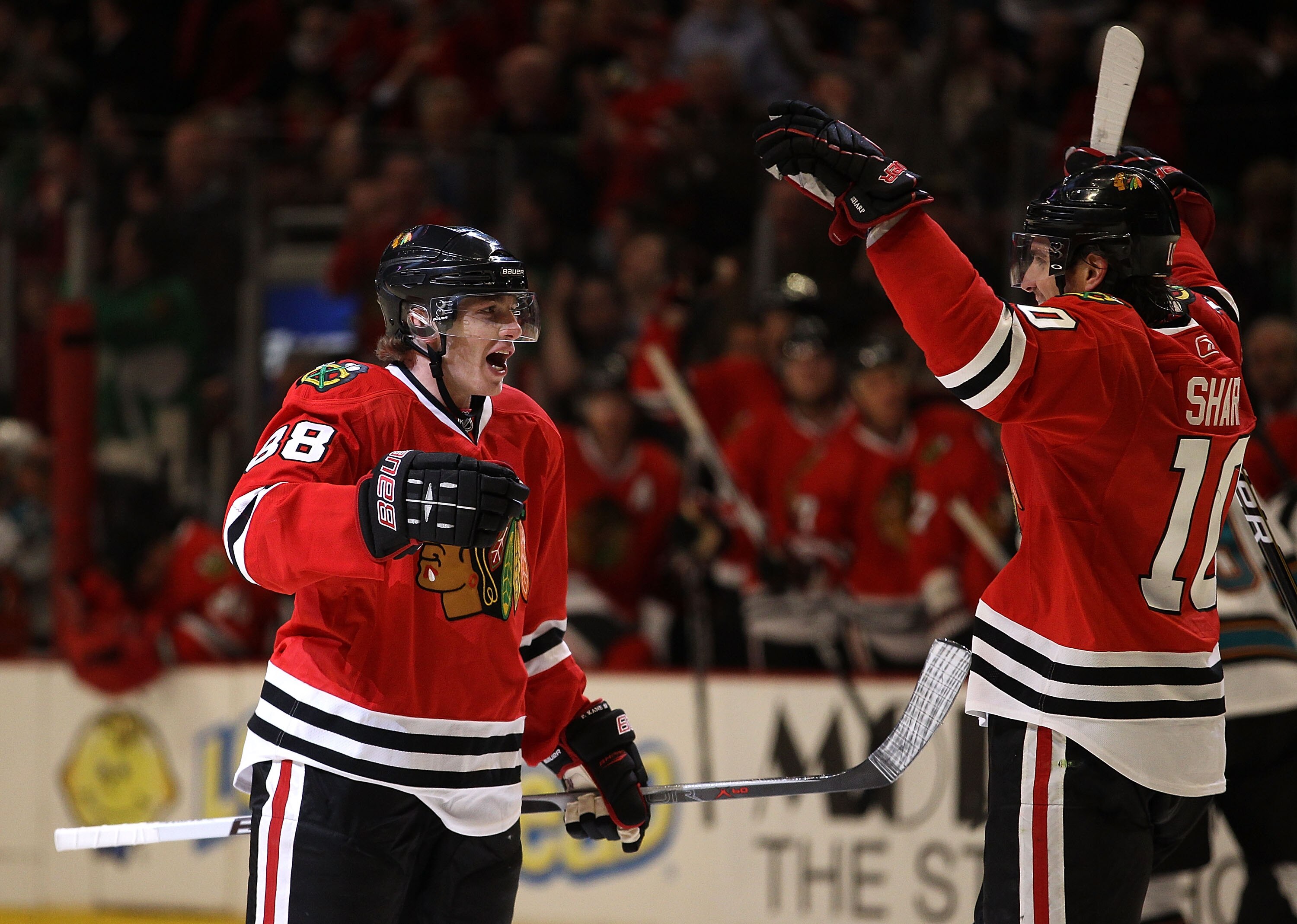 CHICAGO, IL - MARCH 14: Patrick Kane #88 of the Chicago Blackhawks celebrates the one hundredth goal of his career in the 2nd period with teammate Patrick Sharp #10 against the San Jose Sharks at the United Center on March 14, 2011 in Chicago, Illinois.