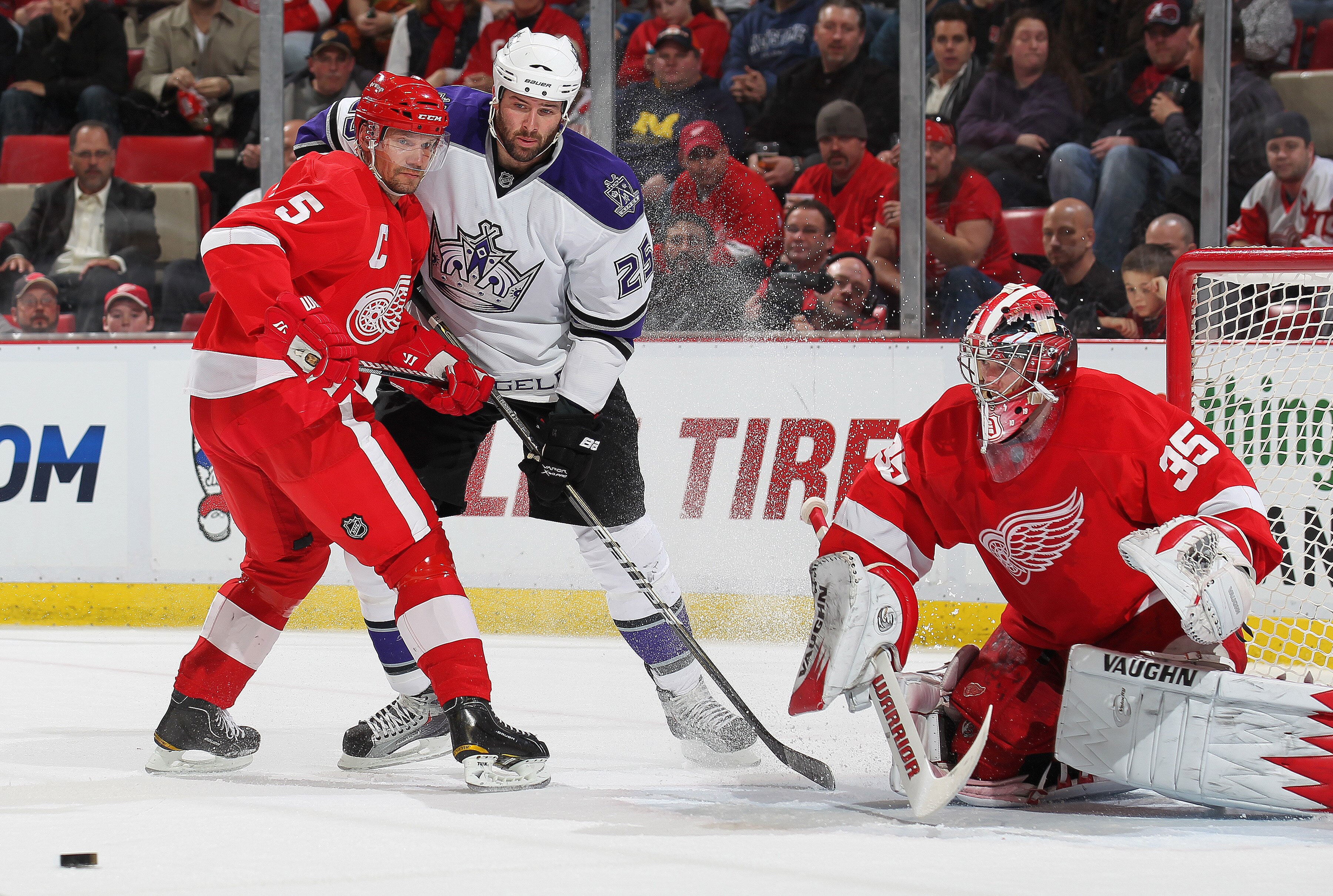 DETROIT, MI - MARCH 9:  Dustin Penner #25 of the Los Angeles Kings tries to get free from Nicklas Lidstrom #5 of the Detroit Red Wings to deflect a shot in a game on March 9, 2011 at the Joe Louis Arena in Detroit, Michigan. (Photo by Claus Andersen/Getty