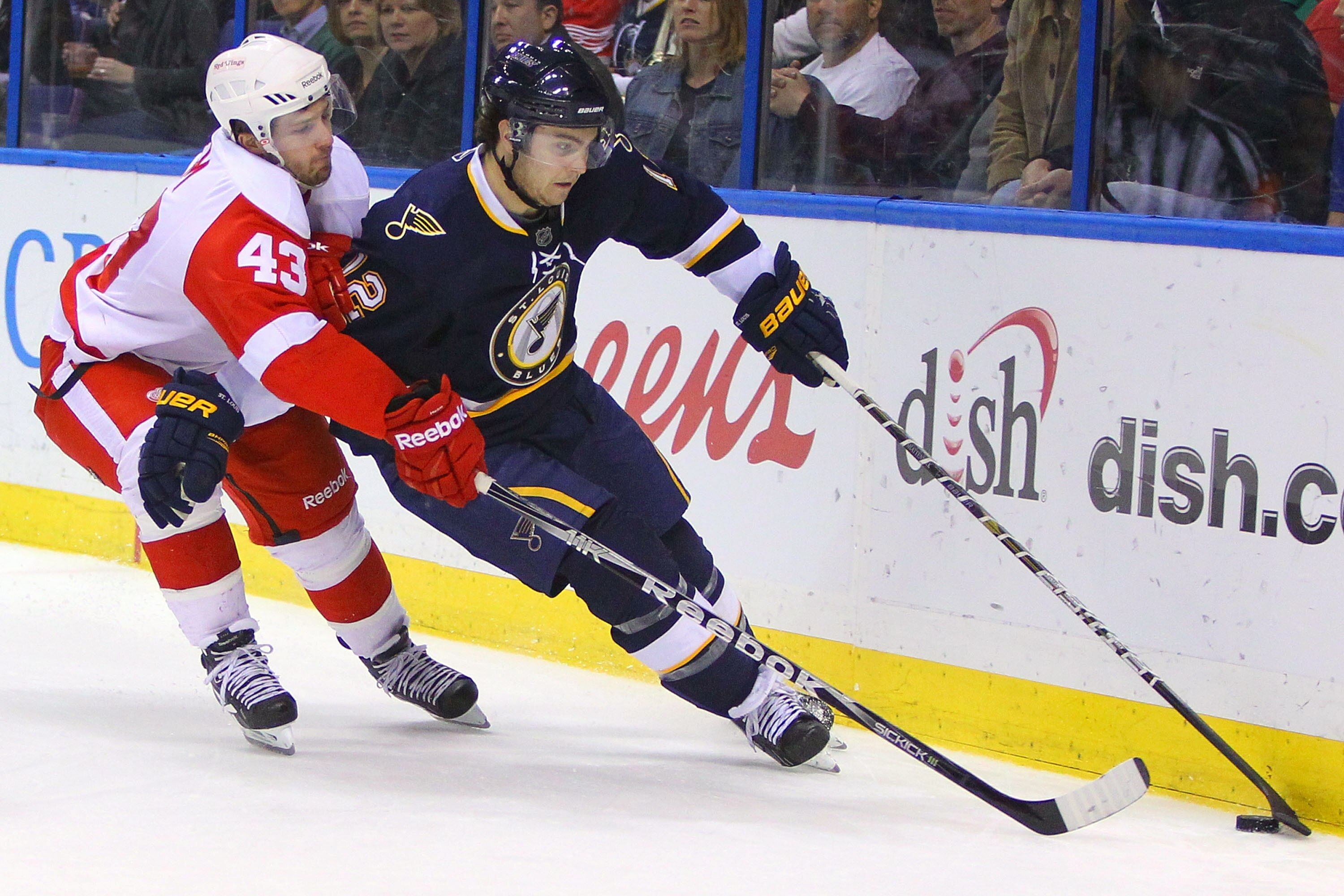ST. LOUIS, MO - MARCH 12: Kevin Shattenkirk #12 of the St. Louis Blues controls the puck against Darren Helm #43 of the Detroit Red Wings at the Scottrade Center on March 12, 2011 in St. Louis, Missouri.  (Photo by Dilip Vishwanat/Getty Images)