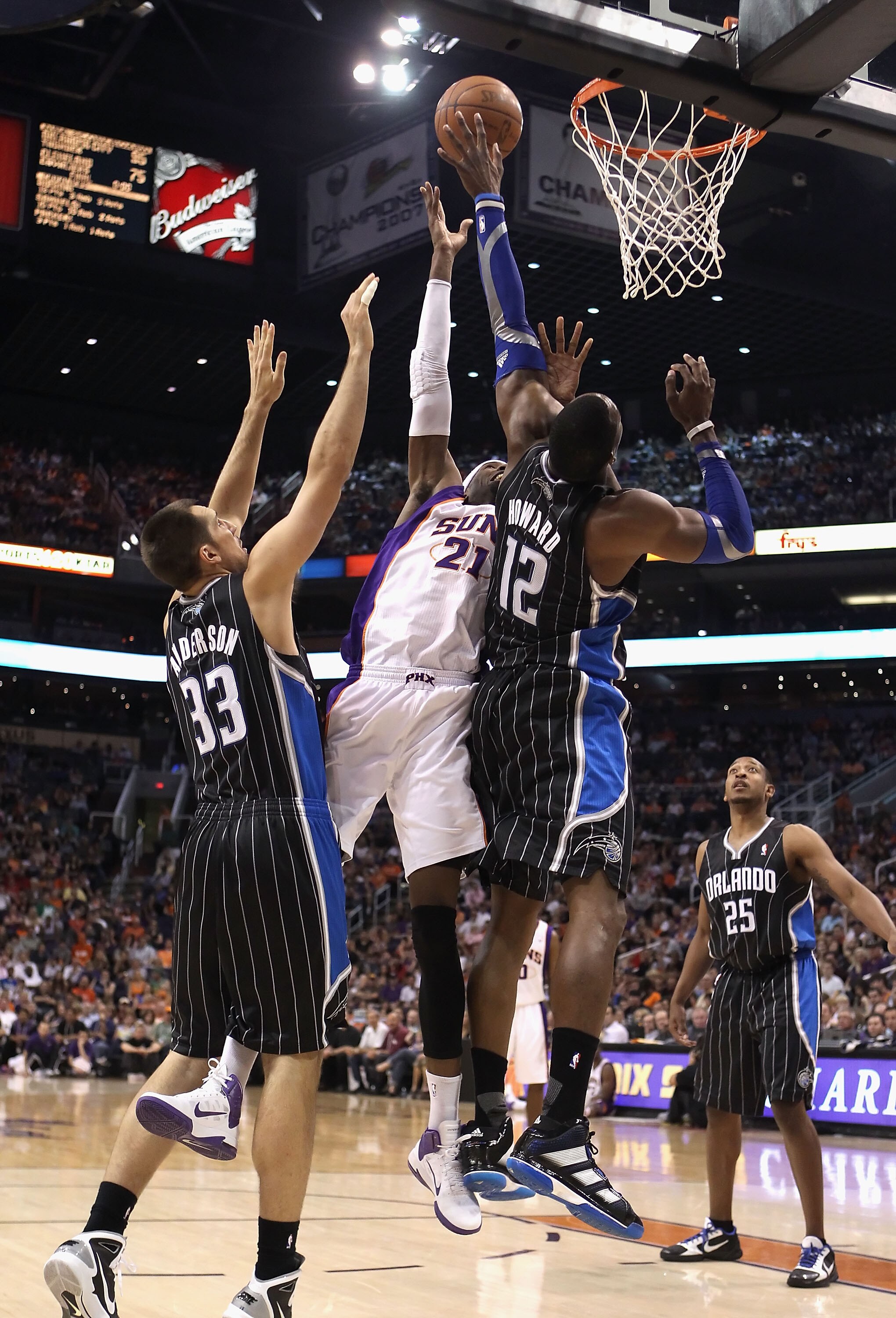 PHOENIX, AZ - MARCH 13:  Hakim Warrick #21 of the Phoenix Suns attempts a shot over Dwight Howard #12 of the Orlando Magic during the NBA game at US Airways Center on March 13, 2011 in Phoenix, Arizona. The Magic defeated the Suns 111-88.  NOTE TO USER: U