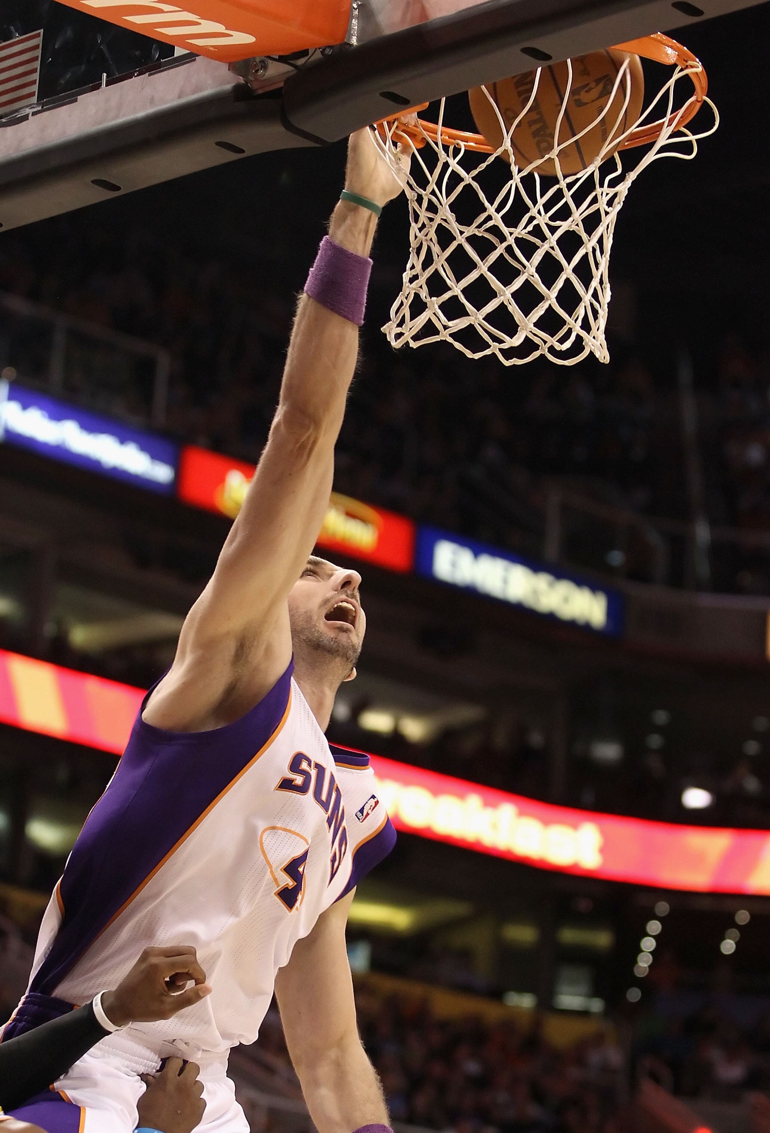 PHOENIX, AZ - JANUARY 30: Marcin Gortat #4 of the Phoenix Suns slam dunks the ball against the New Orleans Hornets during the NBA game at US Airways Center on January 30, 2011 in Phoenix, Arizona. The Suns defeated the Hornets 104-102. NOTE TO USER: Use PHOENIX, AZ - JANUARY 30: Marcin Gortat #4 of the Phoenix Suns slam dunks the ball against the New Orleans Hornets during the NBA game at US Airways Center on January 30, 2011 in Phoenix, Arizona. The Suns defeated the Hornets 104-102. NOTE TO USER: Use