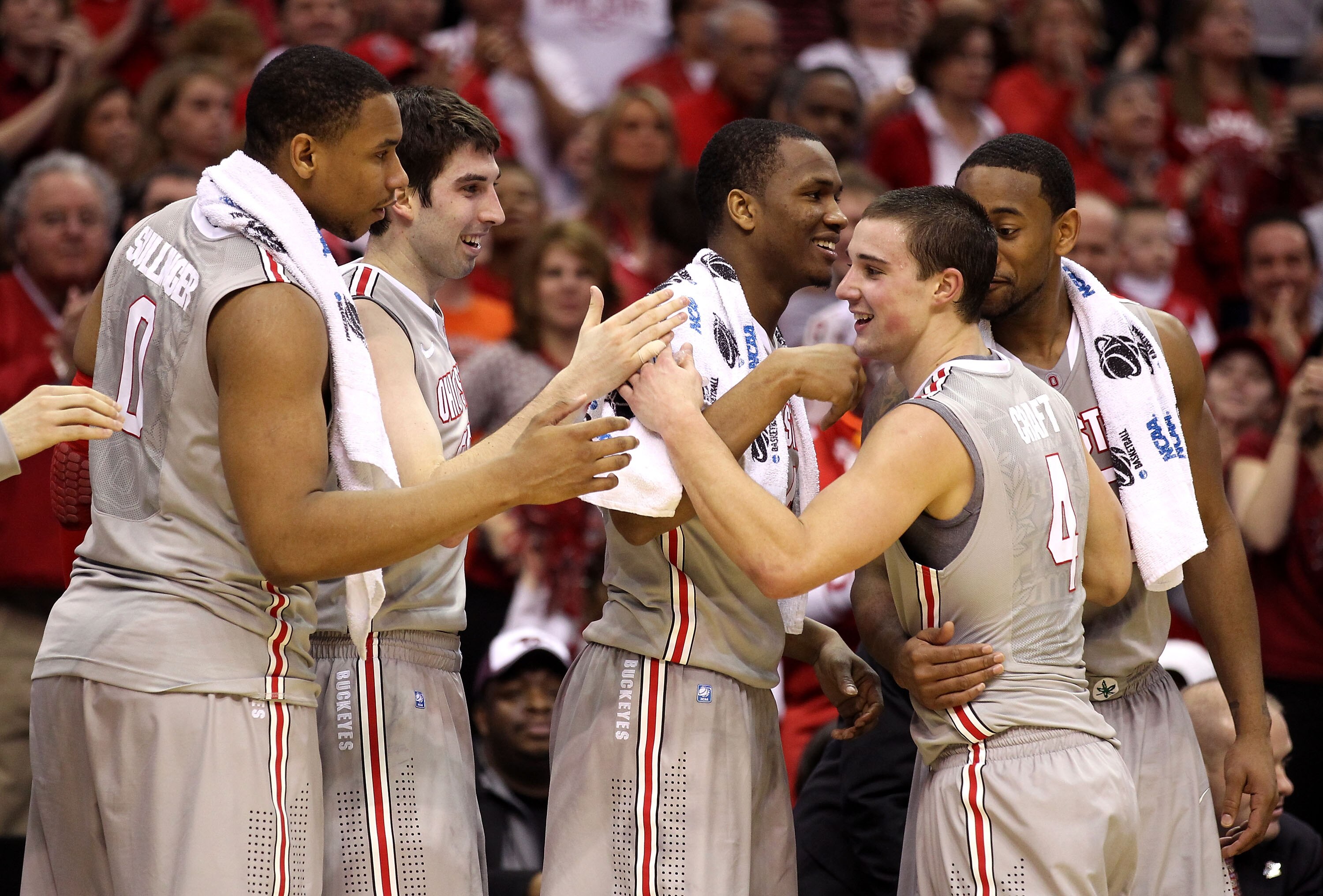 CLEVELAND, OH - MARCH 20: Jared Sullinger #0, Jon Diebler #33, William Buford #44 and David Lighty #23 of the Ohio State Buckeyes greet Aaron Craft #4 as he comes to the bench late in the game against the George Mason Patriots during the third of the 2011