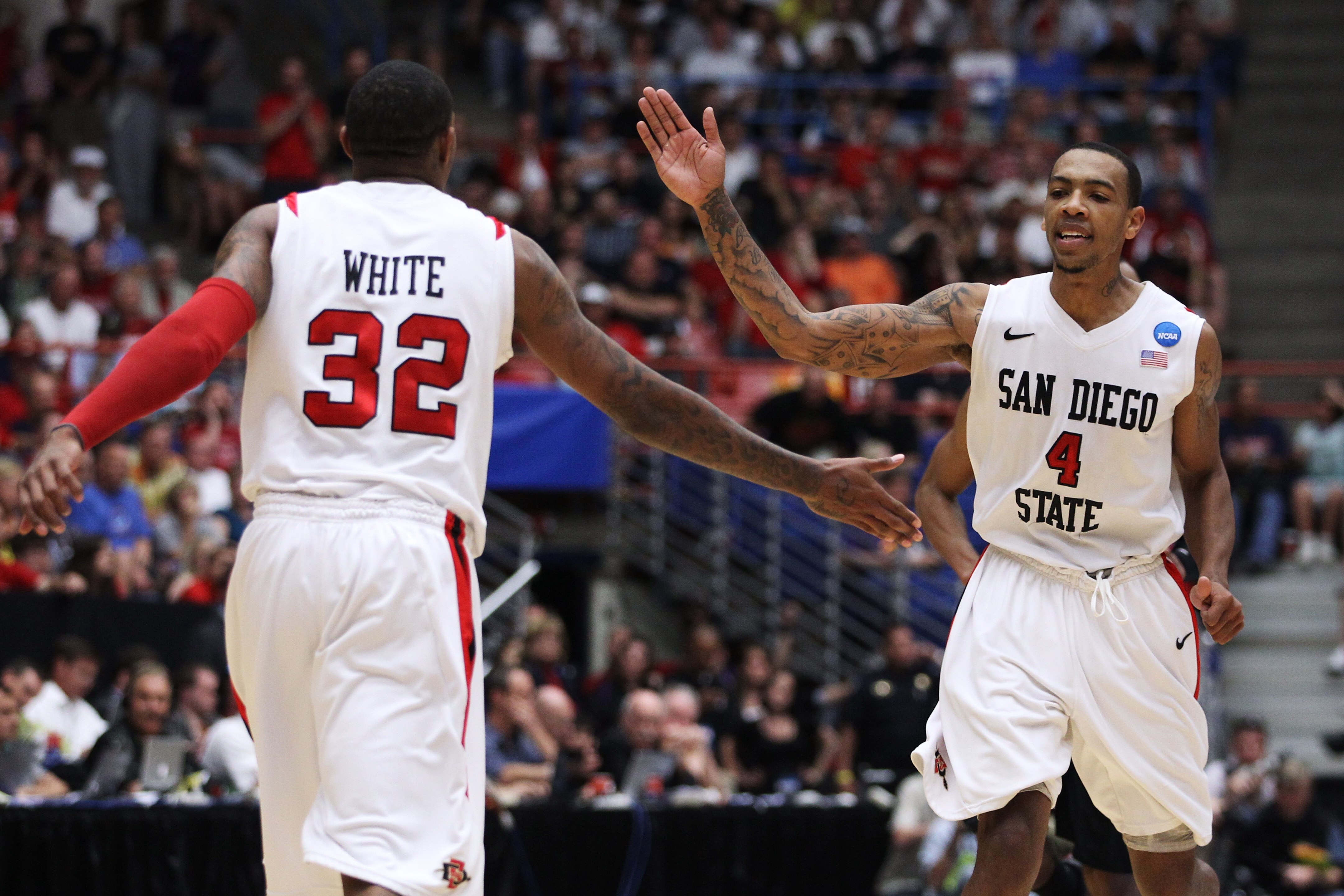 TUCSON, AZ - MARCH 19:  Malcolm Thomas #4 and Billy White #32 of the San Diego State Aztecs celebrate after defeating the Temple Owls 71 to 64 in double overtime during the third round of the 2011 NCAA men's basketball tournament at McKale Center on March