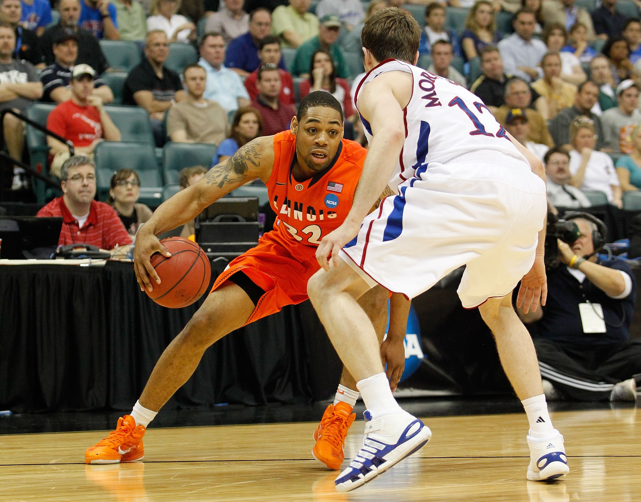 TULSA, OK - MARCH 20:  Demetri McCamey #32 of the Illinois Fighting Illini drives with the ball against Brady Morningstar #12 of the Kansas Jayhawks during the third round of the 2011 NCAA men's basketball tournament at BOK Center on March 20, 2011 in Tul