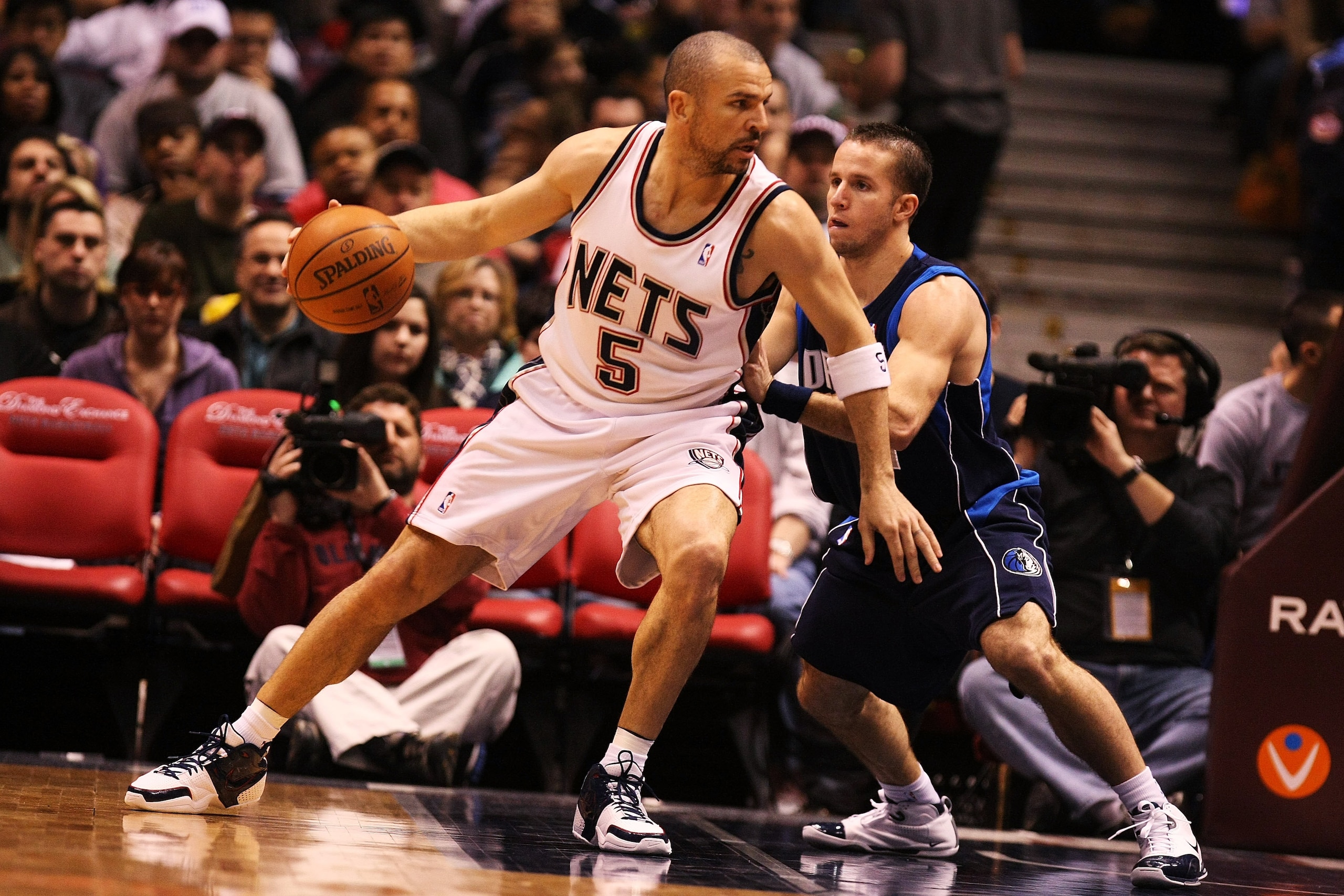 EAST RUTHERFORD, NJ - FEBRUARY 10:  Jason Kidd #5 of the New Jersey Nets leans into Jose Barea #11 of the Dallas Mavericks during their game at the Izod Center February 10, 2008 in East Rutherford, New Jersey.  NOTE TO USER: User expressly acknowledges an