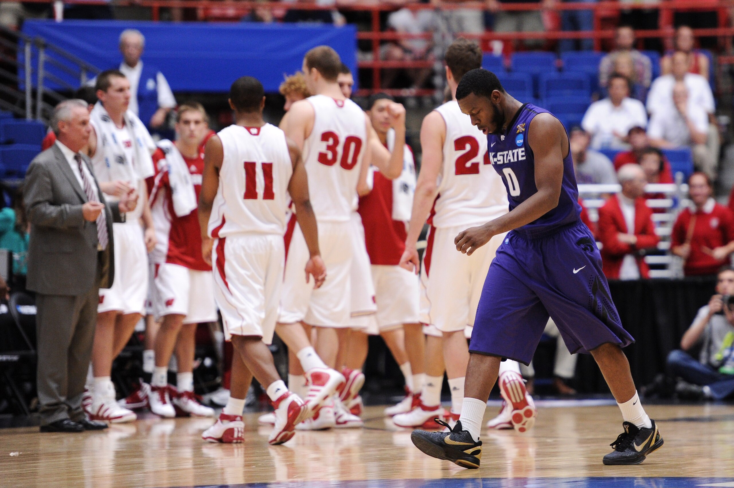TUCSON, AZ - MARCH 19:  Jacob Pullen #0 of the Kansas State Wildcats walks across the court dejected after the Wisconsin Badgers defeated the Wildcats 70 to 65 during the third round of the 2011 NCAA men's basketball tournament at McKale Center on March 1