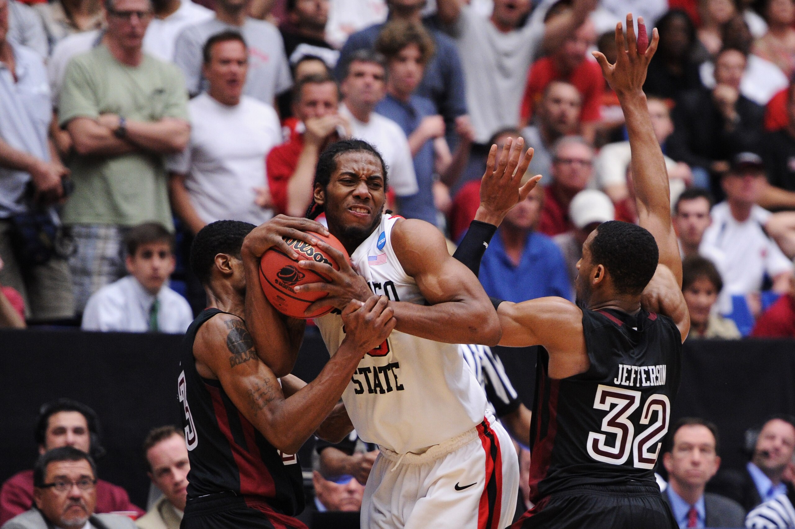 TUCSON, AZ - MARCH 19:  Ramone Moore #23 and Rahlir Jefferson #32 of the Temple Owls attempt to steal from Kawhi Leonard #15 of the San Diego State Aztecs in double overtime during the third round of the 2011 NCAA men's basketball tournament at McKale Cen