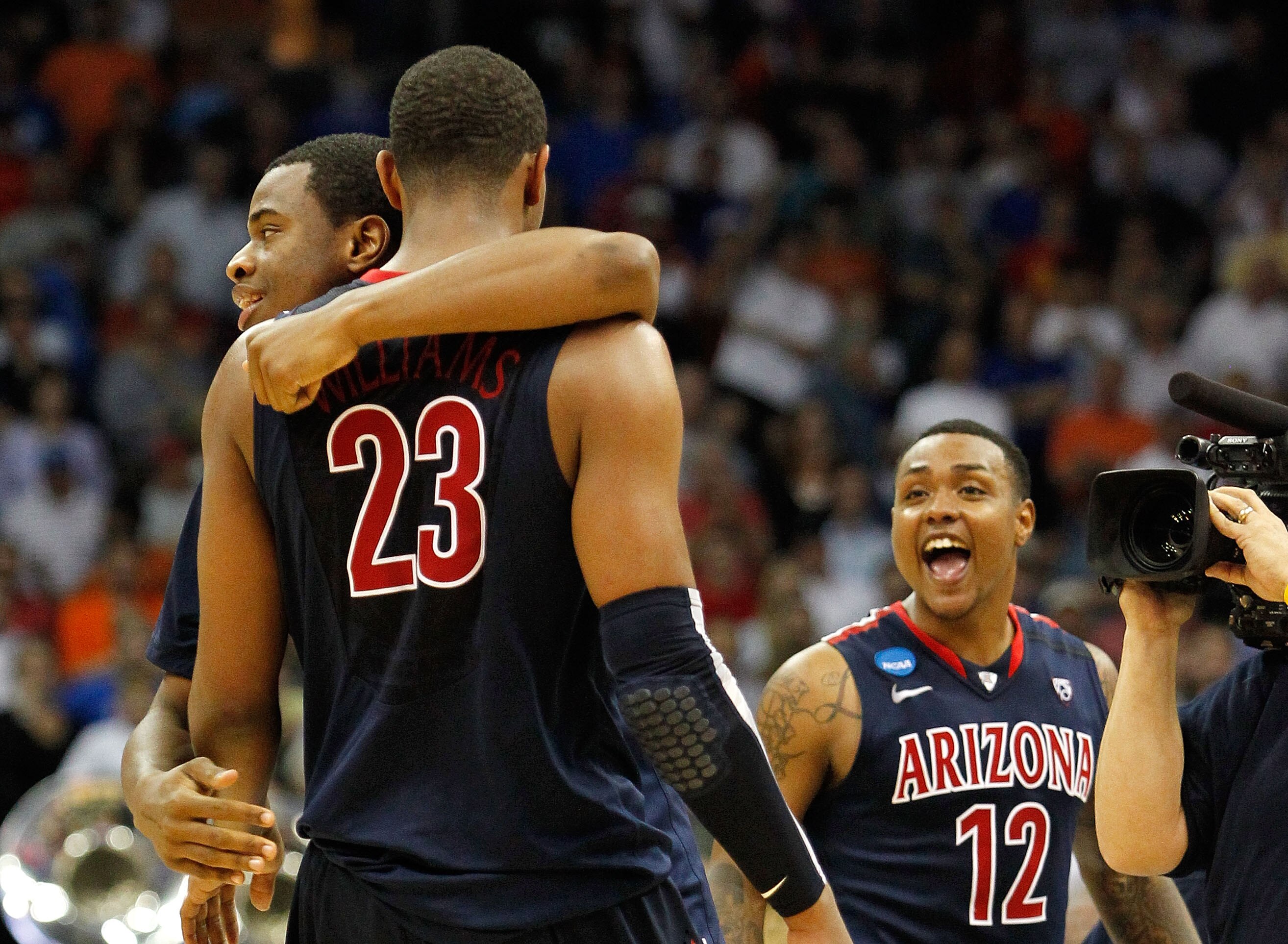 TULSA, OK - MARCH 20:  Derrick Williams #23 of the Arizona Wildcats celebrates with teammates Kevin Parrom #3 and Lamont Jones #12 after defeating the Texas Longhorns 70-69 in the third round of the 2011 NCAA men's basketball tournament at BOK Center on M