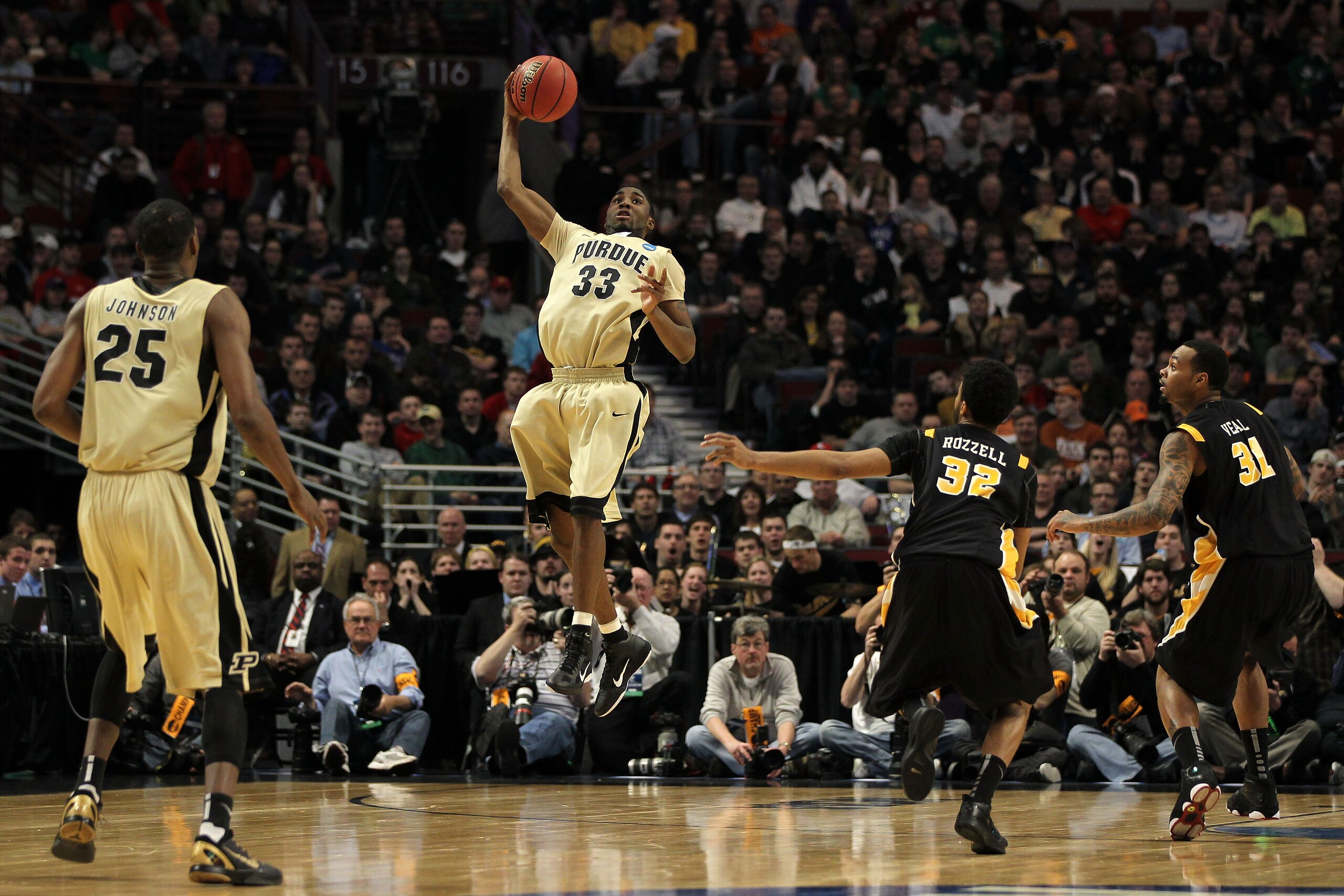 CHICAGO, IL - MARCH 20:  E'Twaun Moore #33 of the Purdue Boilermakers catches the ball as Brandon Rozzell #32 and Toby Veal #31 of the Virginia Commonwealth Rams look on in the first half during the third round of the 2011 NCAA men's basketball tournament