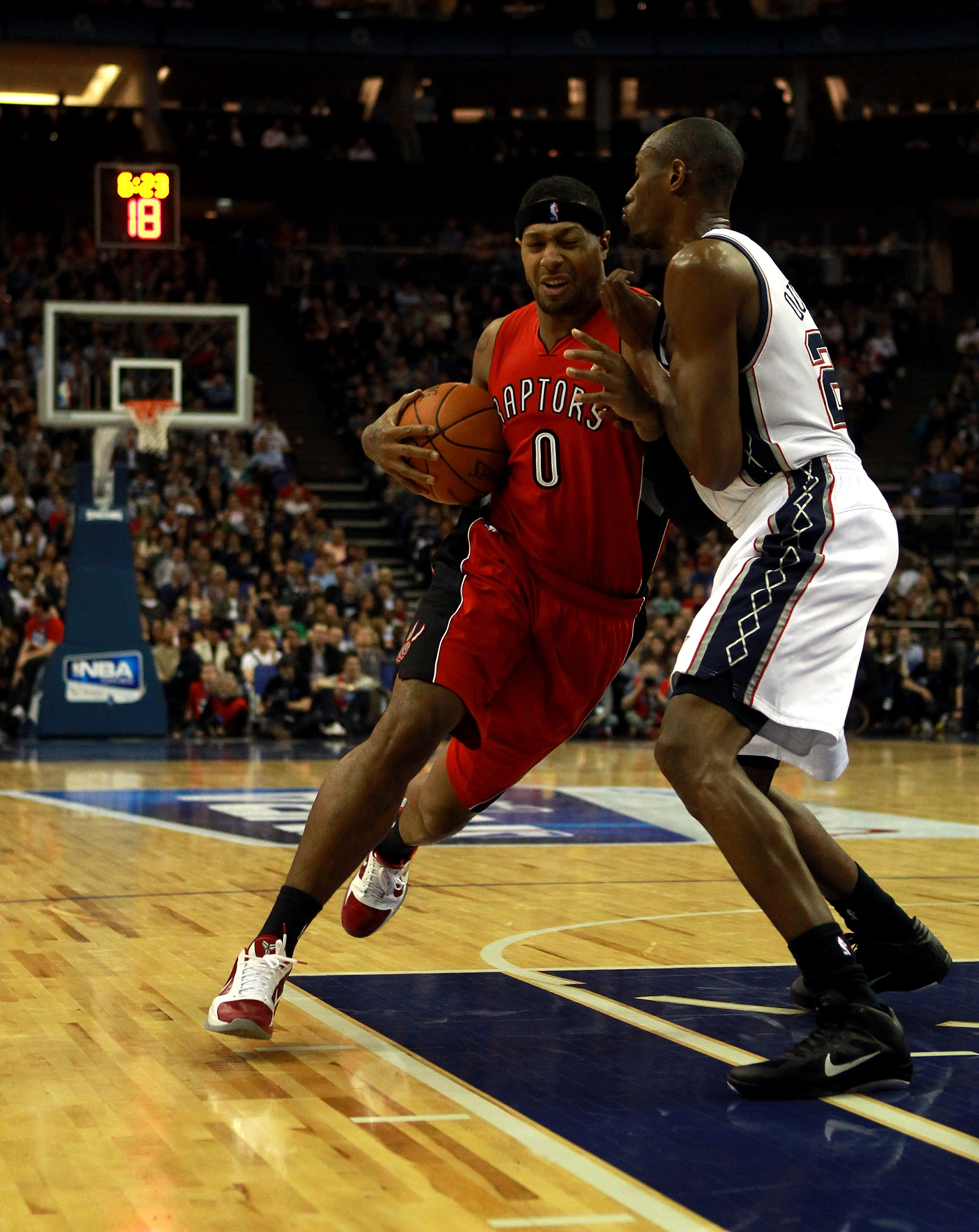 LONDON, ENGLAND - MARCH 04: James Johnson #0 of the Raptors fends off Travis Outlaw #21 of the Nets during the NBA match between New Jersey Nets and the Toronto Raptors at the O2 Arena on March 4, 2011 in London, England. NOTE TO USER: User expressly ack LONDON, ENGLAND - MARCH 04: James Johnson #0 of the Raptors fends off Travis Outlaw #21 of the Nets during the NBA match between New Jersey Nets and the Toronto Raptors at the O2 Arena on March 4, 2011 in London, England. NOTE TO USER: User expressly ack