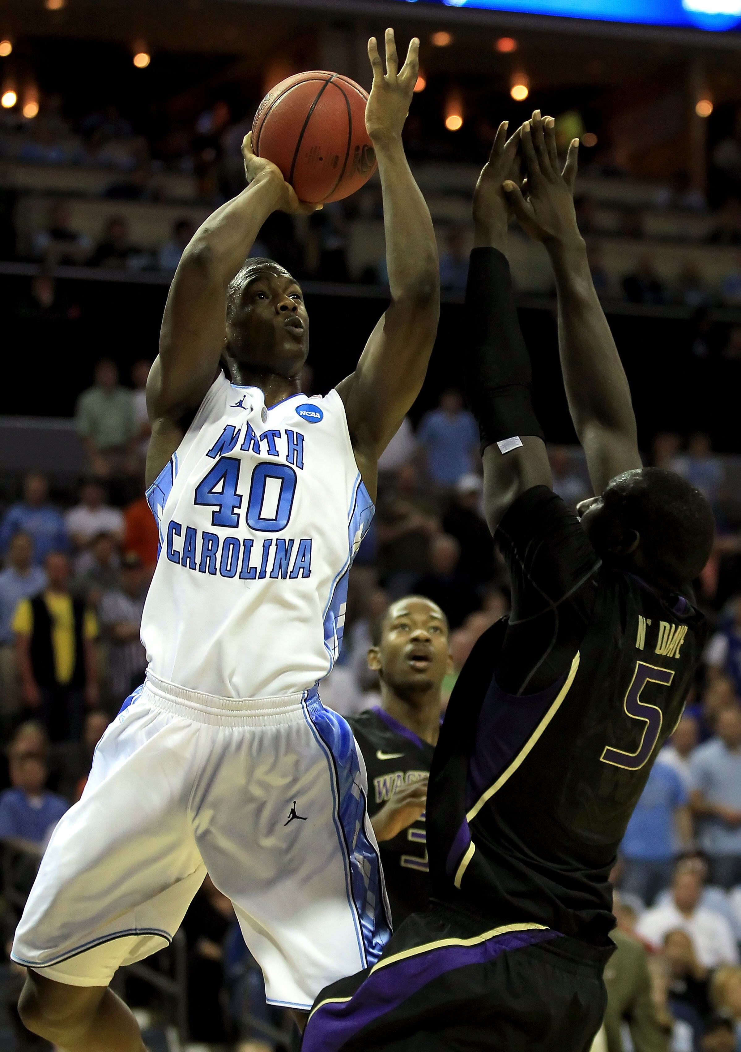 CHARLOTTE, NC - MARCH 20:  Harrison Barnes #40 of the North Carolina Tar Heels shoots over Aziz N'Diaye #5 of the Washington Huskies in the first half during the third round of the 2011 NCAA men's basketball tournament at Time Warner Cable Arena on March