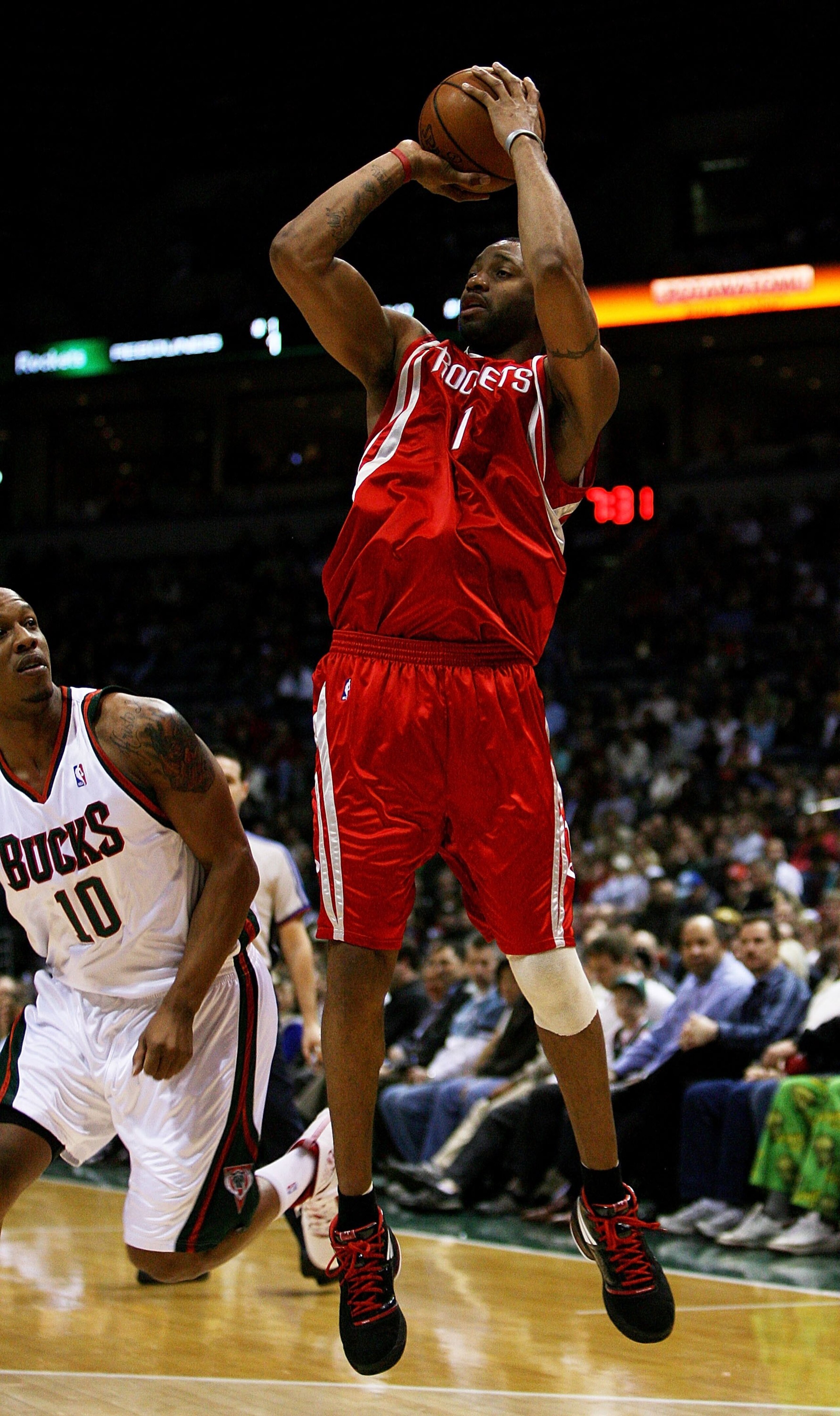MILWAUKEE - FEBRUARY 09: Tracy McGrady #1 of the Houston Rockets puts up a shot over Keith Bogans #10 of the Milwaukee Bucks on February 9, 2009 at the Bradley Center in Milwaukee, Wisconsin. The Bucks defeated the Rockets 124-112. NOTE TO USER: User expr