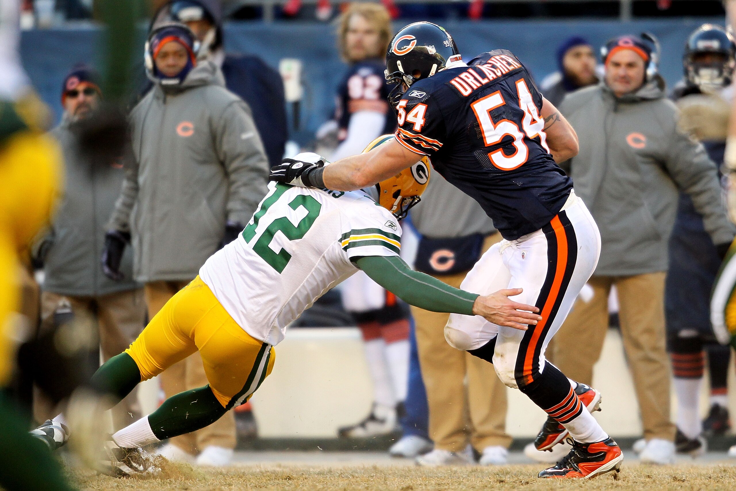 CHICAGO, IL - JANUARY 23: Linebacker Brian Urlacher #54 of the Chicago Bears is tackled by quarterback Aaron Rodgers #12 of the Green Bay Packers after Urlacher runs an interception 39-yards in the third quarter in the NFC Championship Game at Soldier Fi CHICAGO, IL - JANUARY 23: Linebacker Brian Urlacher #54 of the Chicago Bears is tackled by quarterback Aaron Rodgers #12 of the Green Bay Packers after Urlacher runs an interception 39-yards in the third quarter in the NFC Championship Game at Soldier Fi