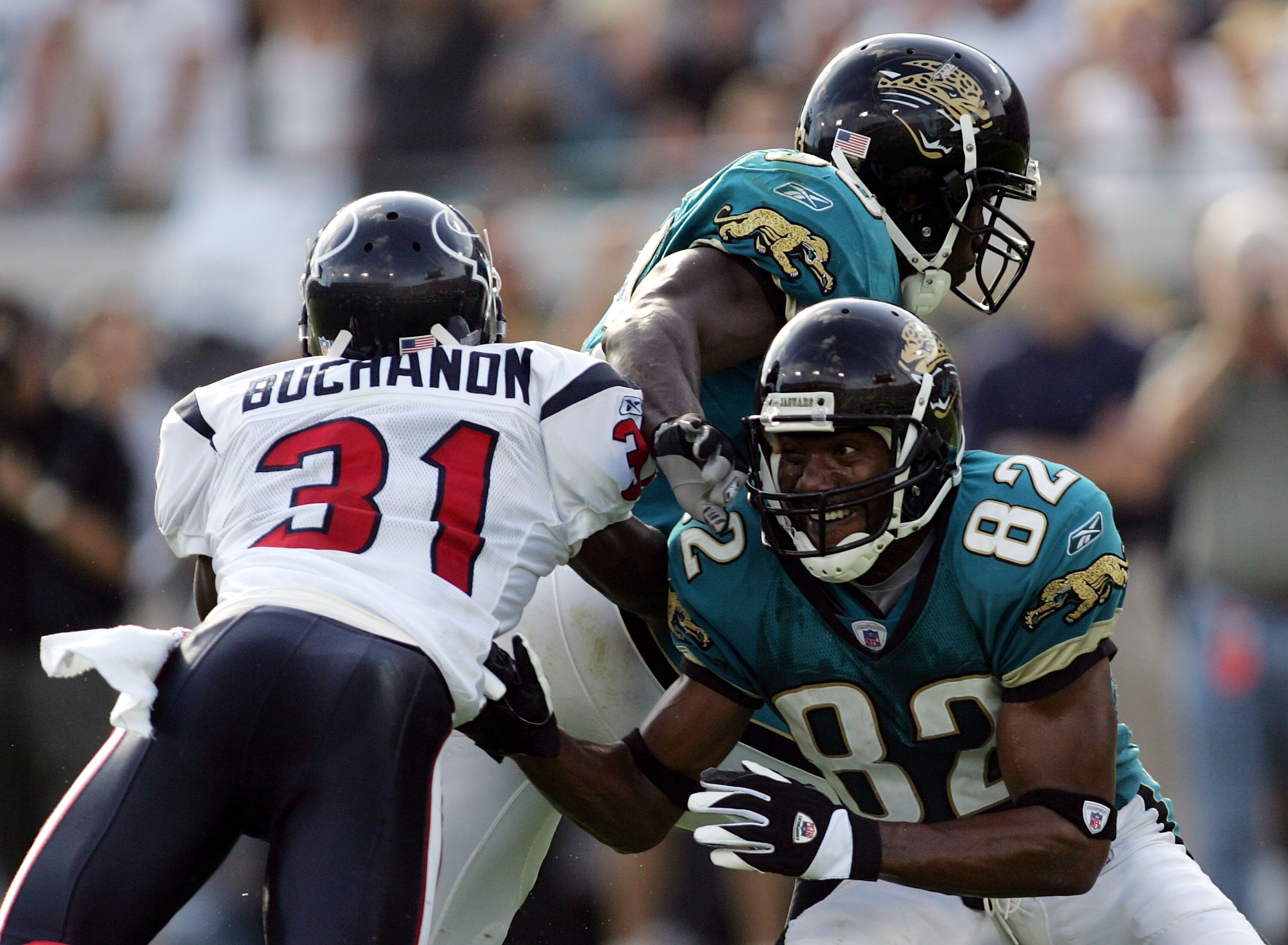 JACKSONVILLE, FL - NOVEMBER 06:  Jimmy Smith #82 of the Jacksonville Jaquars picks up a big block of cornerback Phillip Buchanon #31 of the Houston Texans freeing Greg Jones #33 to run free for a touchdown in the fourth quarter on November 6, 2005 at Allt
