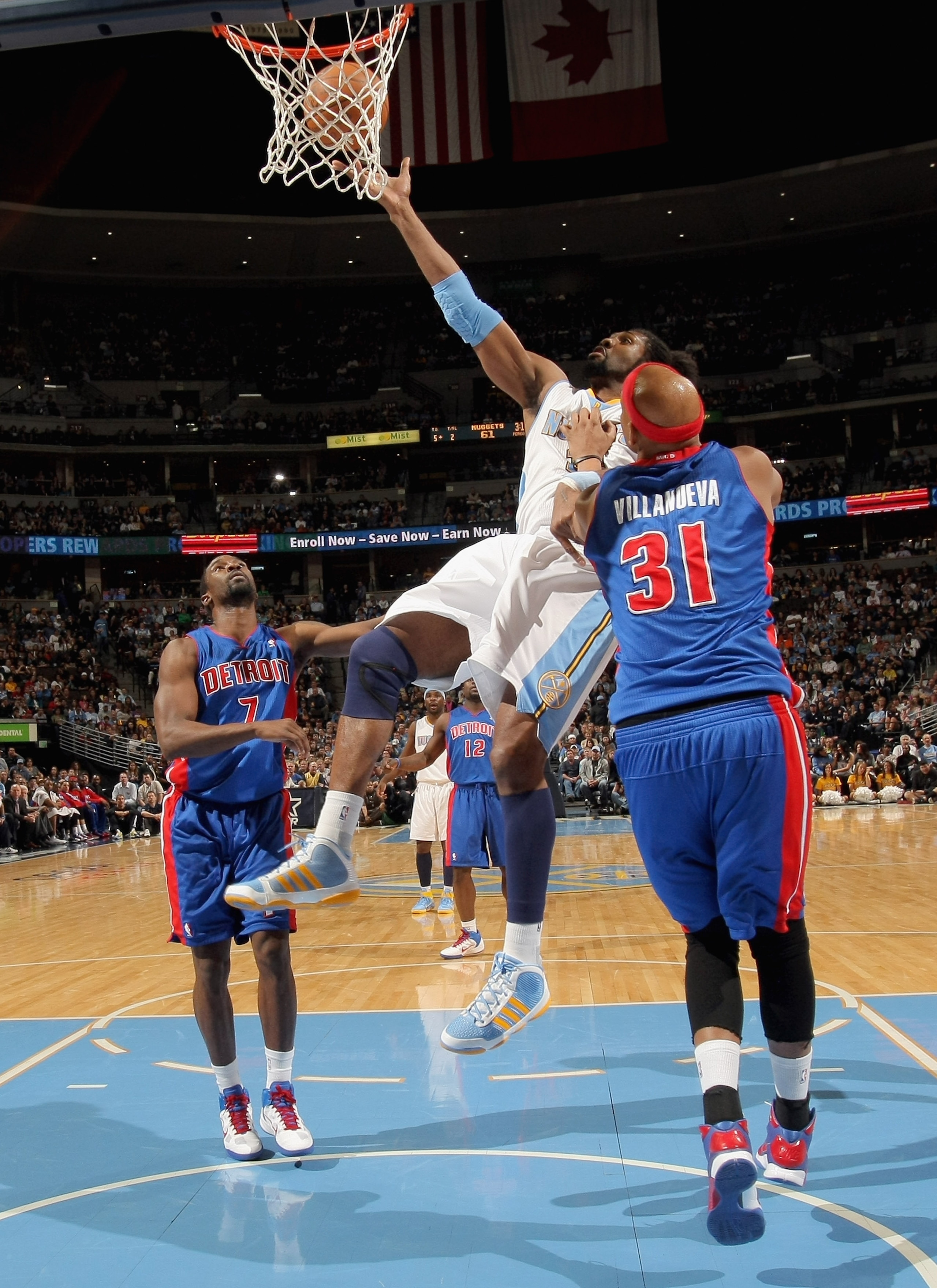 DENVER, CO - MARCH 12:  Nene #31 of the Denver Nuggets is fouled by Charlie Villanueva #31 of the Detroit Pistons as he goes to the basket at the Pepsi Center on March 12, 2011 in Denver, Colorado. NOTE TO USER: User expressly acknowledges and agrees that