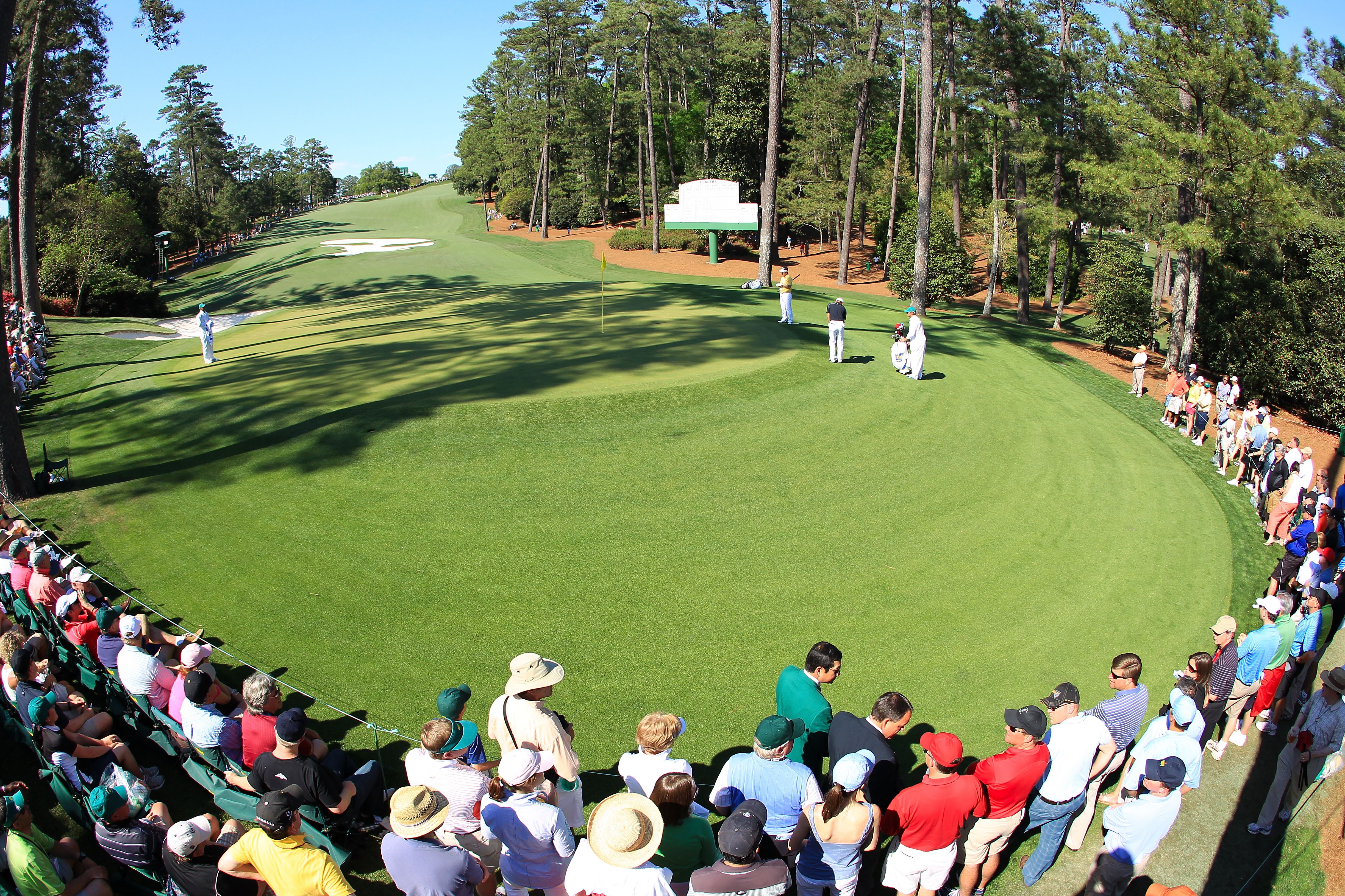 AUGUSTA, GA - APRIL 11:  Patrons watch as Anthony Kim putts on the tenth green during the final round of the 2010 Masters Tournament at Augusta National Golf Club on April 11, 2010 in Augusta, Georgia.  (Photo by David Cannon/Getty Images)