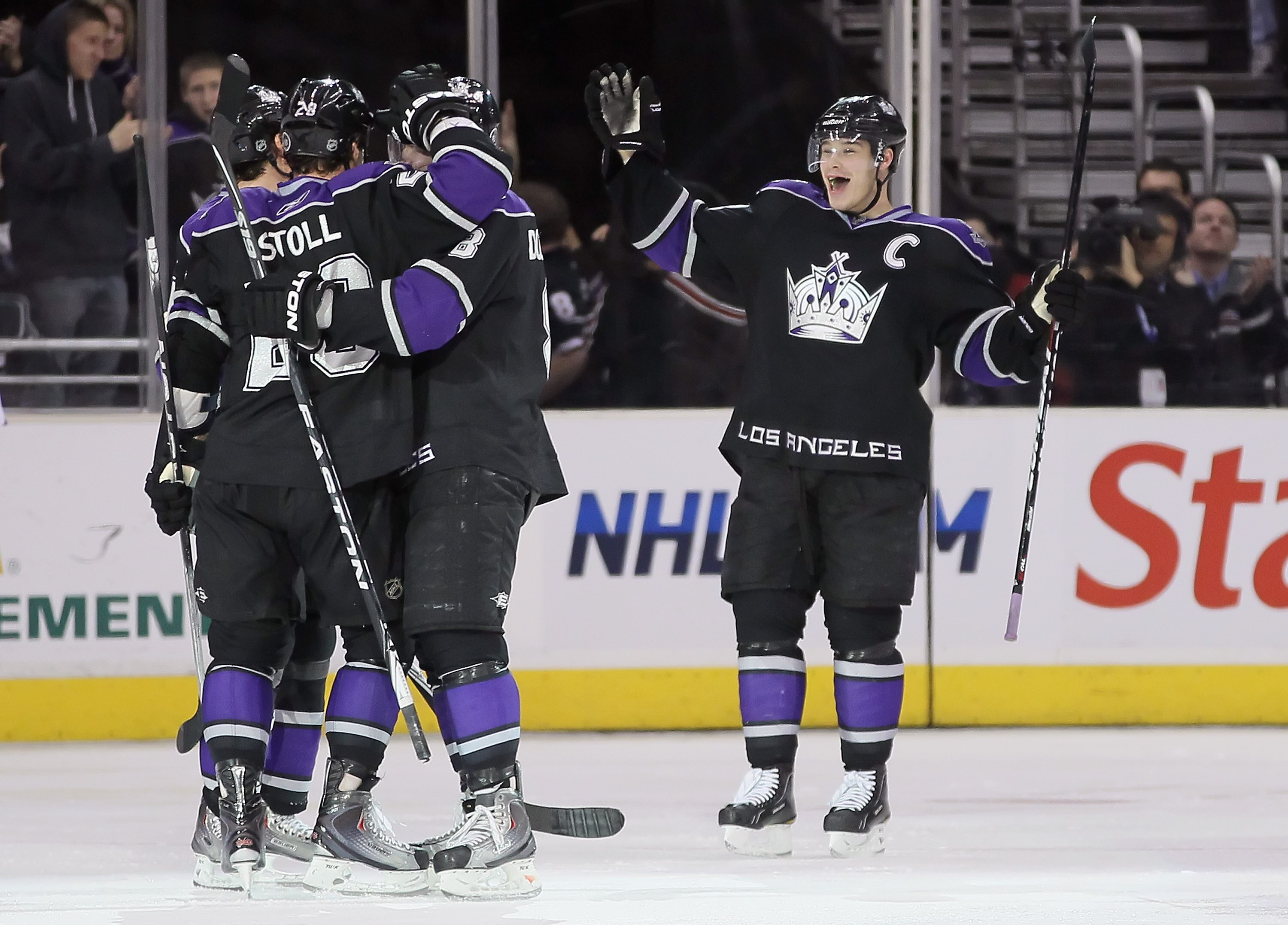 LOS ANGELES, CA - FEBRUARY 26:  (L-R) Jarret Stoll #28, Drew Doughty #8 and Dustin Brown #23 of the Los Angeles Kings celebrate Stoll's third period goal against the Colorado Avalanche at Staples Center on February 26, 2011 in Los Angeles, California. The