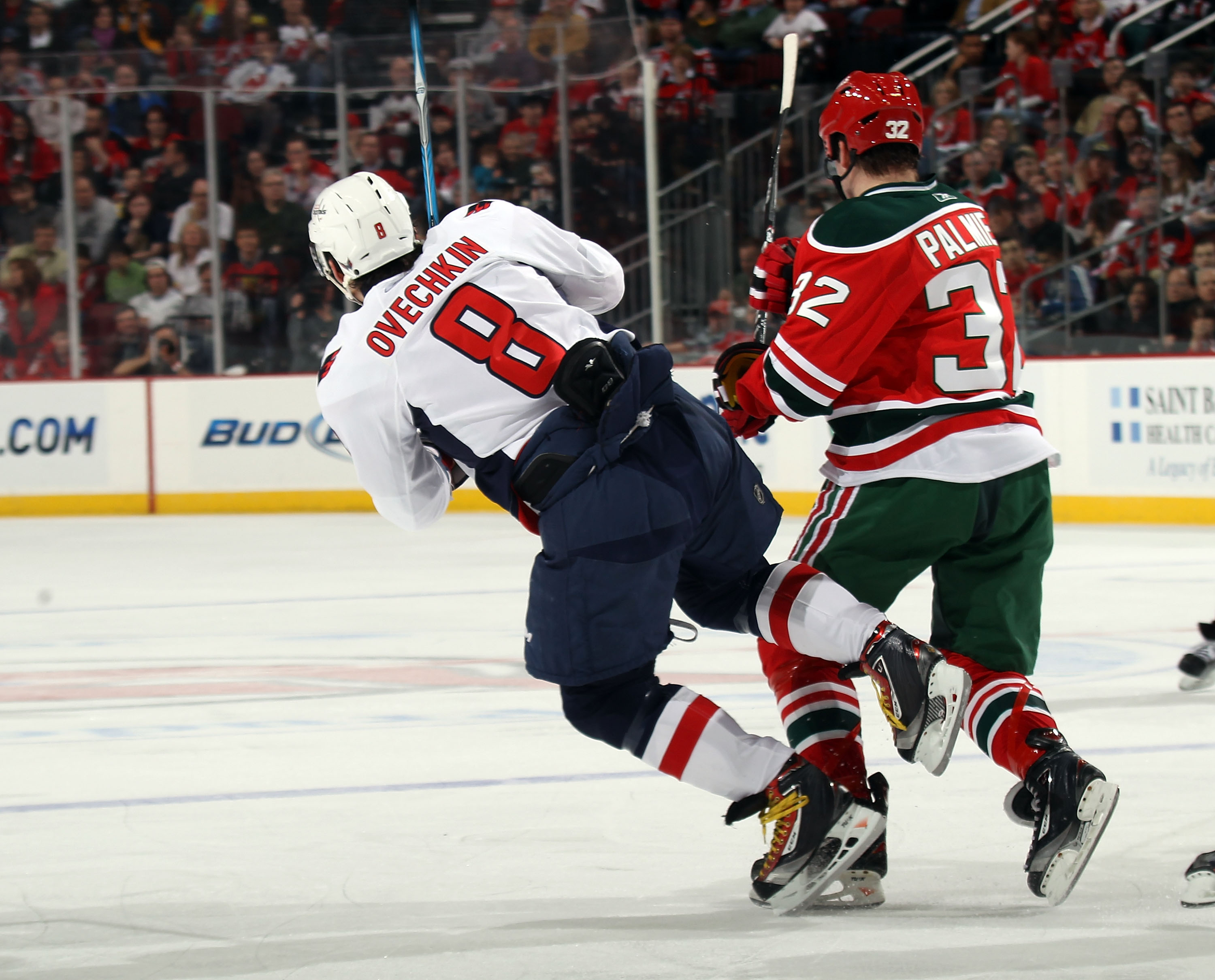 NEWARK, NJ - MARCH 18: Nick Palmieri #32 of the New Jersey Devils bumps Alex Ovechkin #8 of the Washington Capitals at the Prudential Center on March 18, 2011 in Newark, New Jersey. The Capitals defeated the Devils 3-0. (Photo by Bruce Bennett/Getty Image