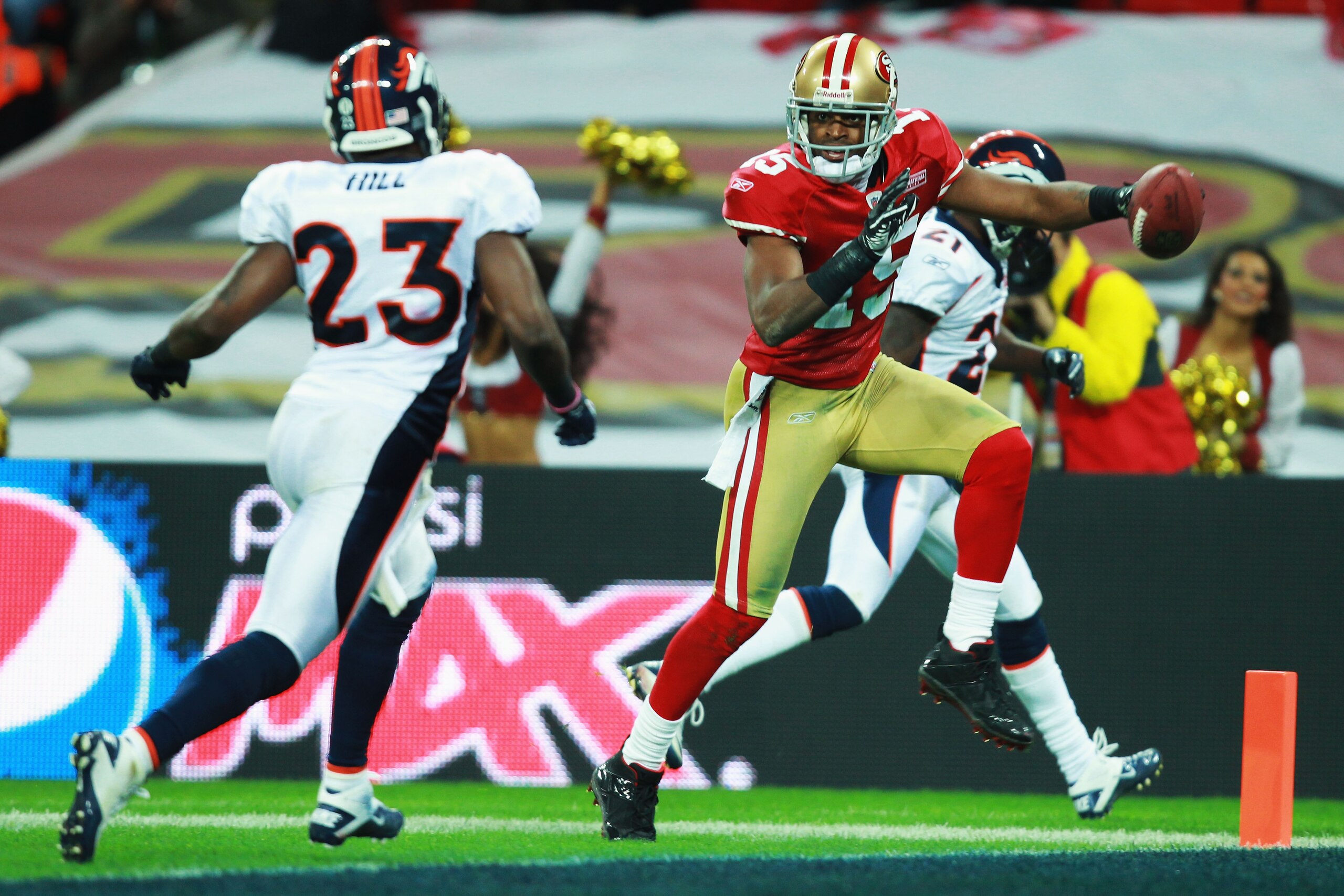 LONDON, ENGLAND - OCTOBER 31:  Michael Crabtree #15 of San Francisco 49ers beats Renaldo Hill #23 of Denver Broncos to score their second touchdown during the NFL International Series match between Denver Broncos and San Francisco 49ers at Wembley Stadium