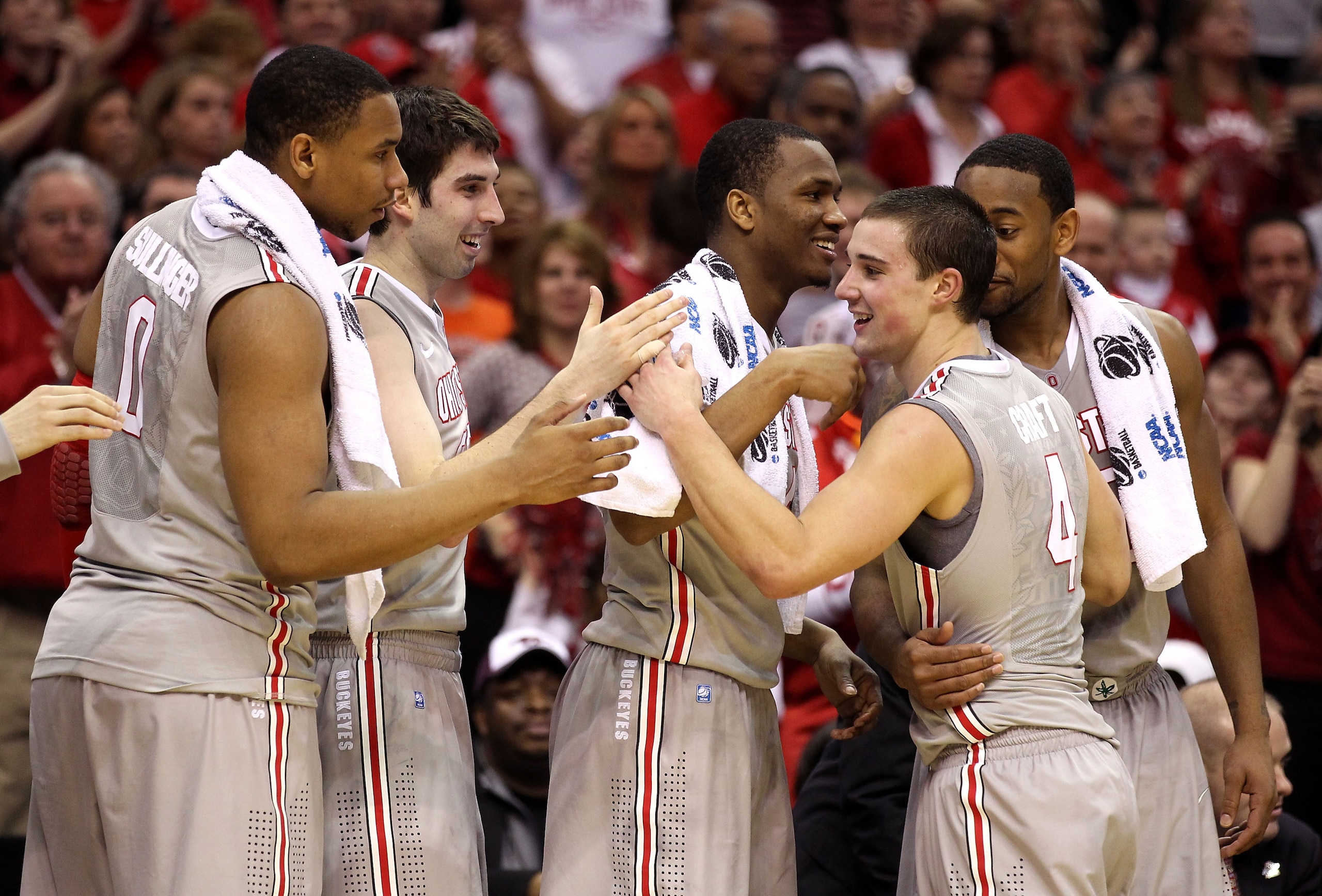 CLEVELAND, OH - MARCH 20: Jared Sullinger #0, Jon Diebler #33, William Buford #44 and David Lighty #23 of the Ohio State Buckeyes greet Aaron Craft #4 as he comes to the bench late in the game against the George Mason Patriots during the third of the 2011
