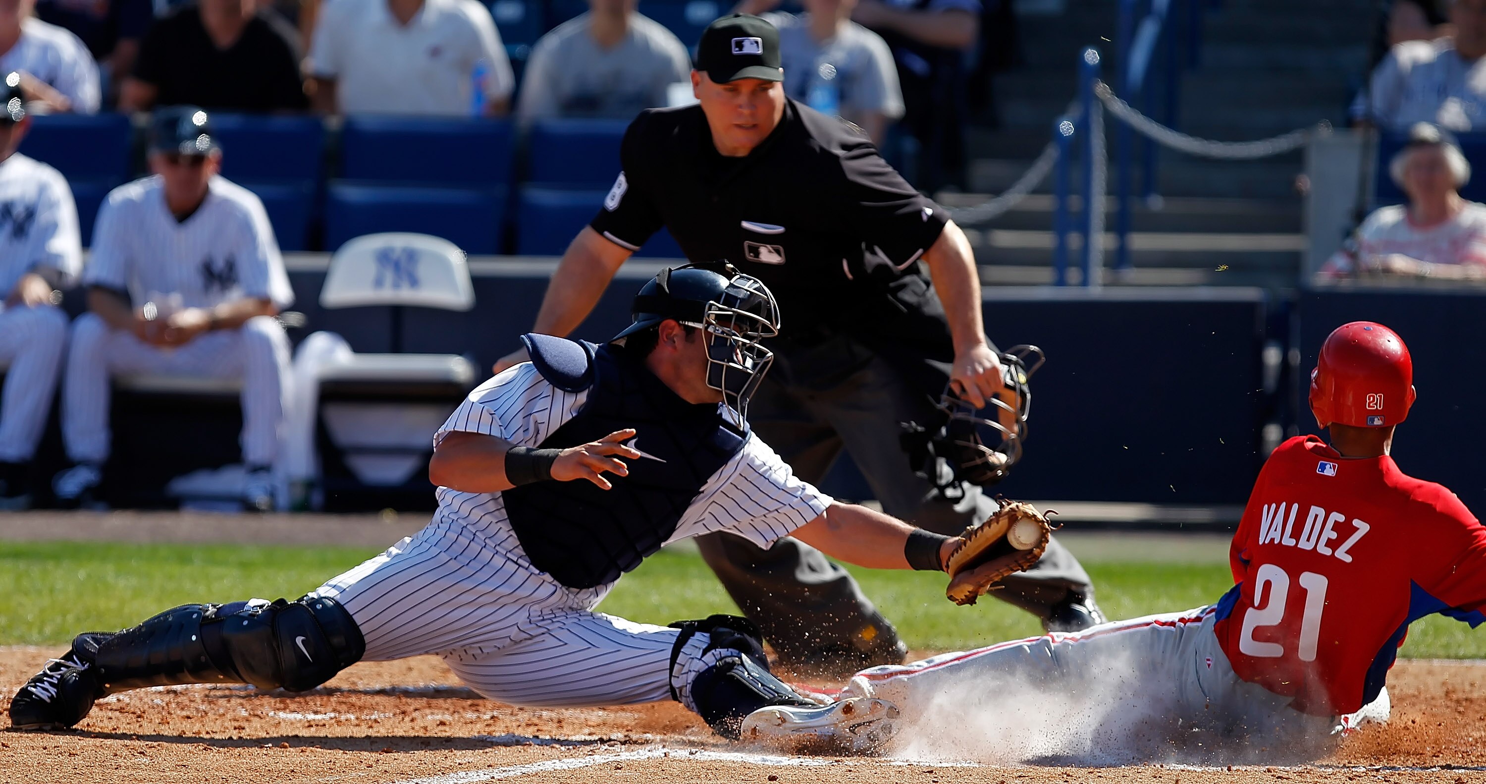 TAMPA, FL - FEBRUARY 26:  Outfielder Wilson Valdez #21 of the Philadelphia Phillies scores a run as catcher Francisco Cervelli #17 of the New York Yankees is late with the tag during a Grapefruit League Spring Training Game at George M. Steinbrenner Field