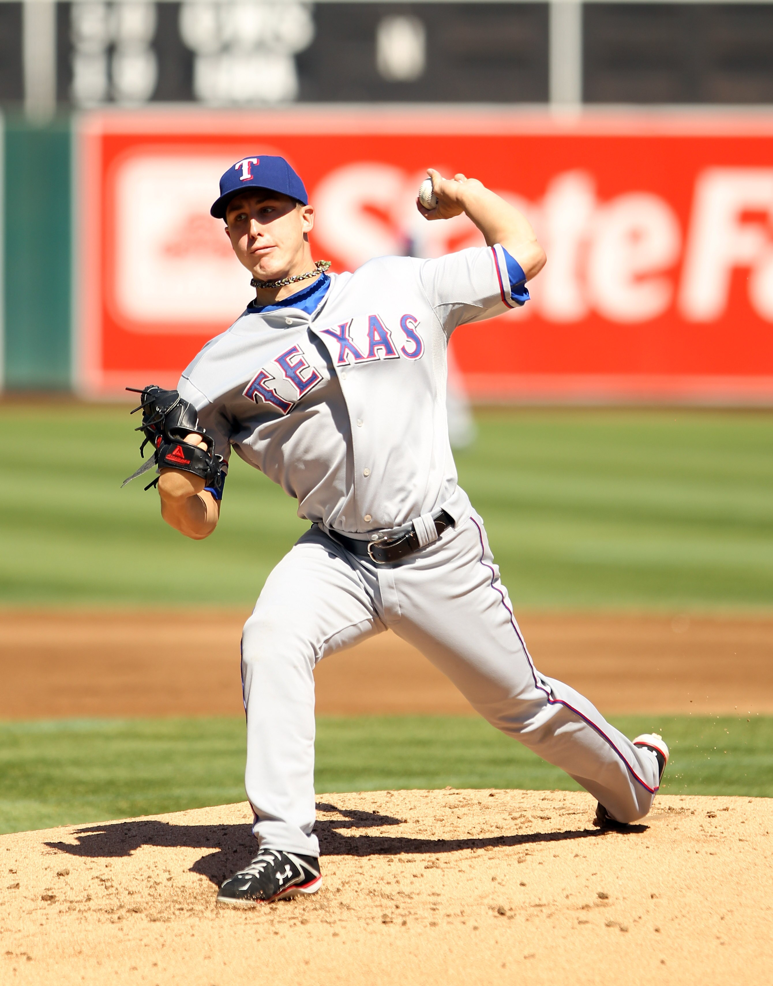 OAKLAND, CA - SEPTEMBER 25:  Derek Holland #45 of the Texas Rangers pitches against the Oakland Athletics at the Oakland-Alameda County Coliseum on September 25, 2010 in Oakland, California.  (Photo by Ezra Shaw/Getty Images)