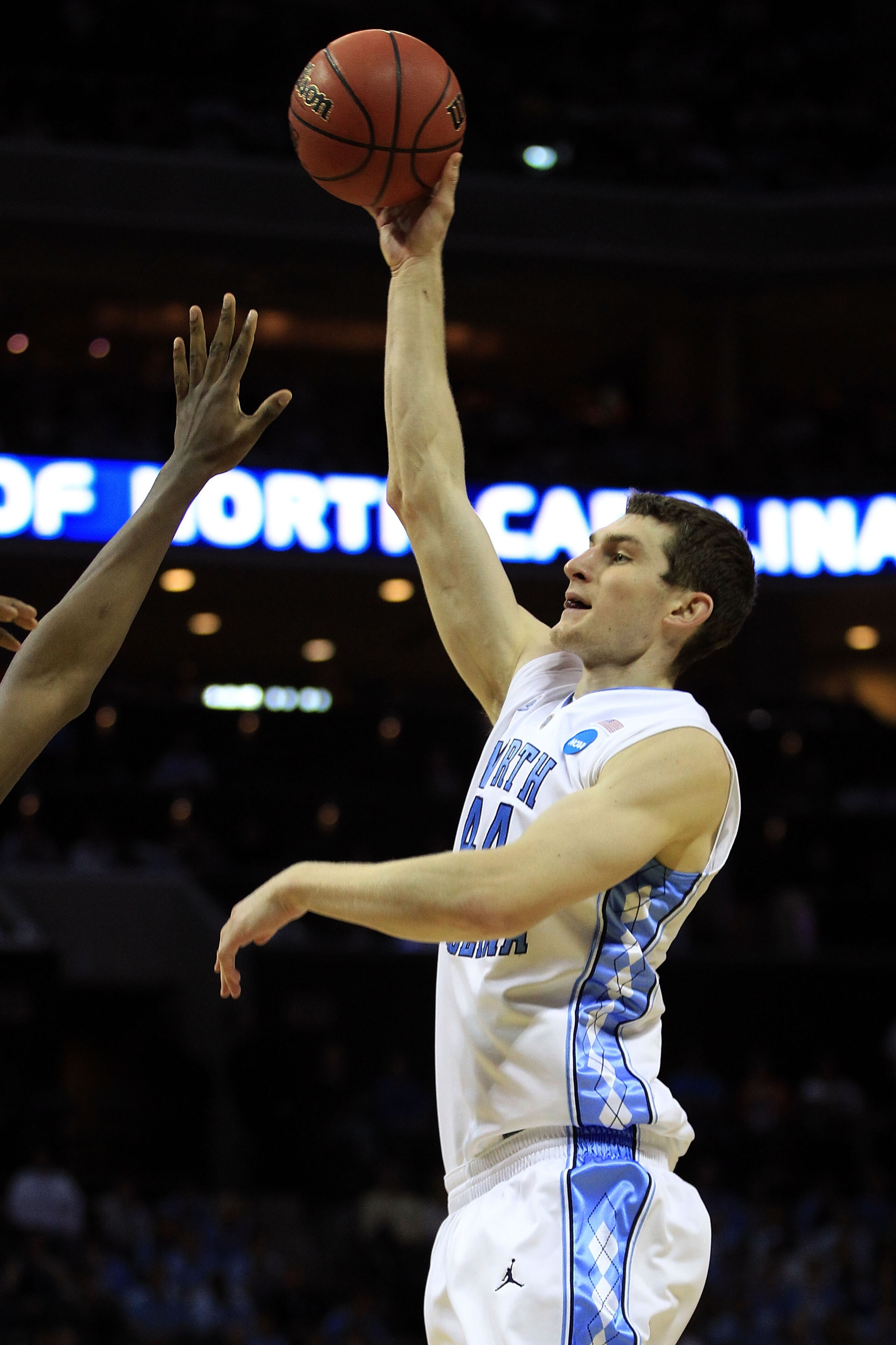 CHARLOTTE, NC - MARCH 20: Tyler Zeller #44 of the North Carolina Tar Heels shoots over a Washington Huskies defender during the third round of the 2011 NCAA men's basketball tournament at Time Warner Cable Arena on March 20, 2011 in Charlotte, North Caro CHARLOTTE, NC - MARCH 20: Tyler Zeller #44 of the North Carolina Tar Heels shoots over a Washington Huskies defender during the third round of the 2011 NCAA men's basketball tournament at Time Warner Cable Arena on March 20, 2011 in Charlotte, North Caro
