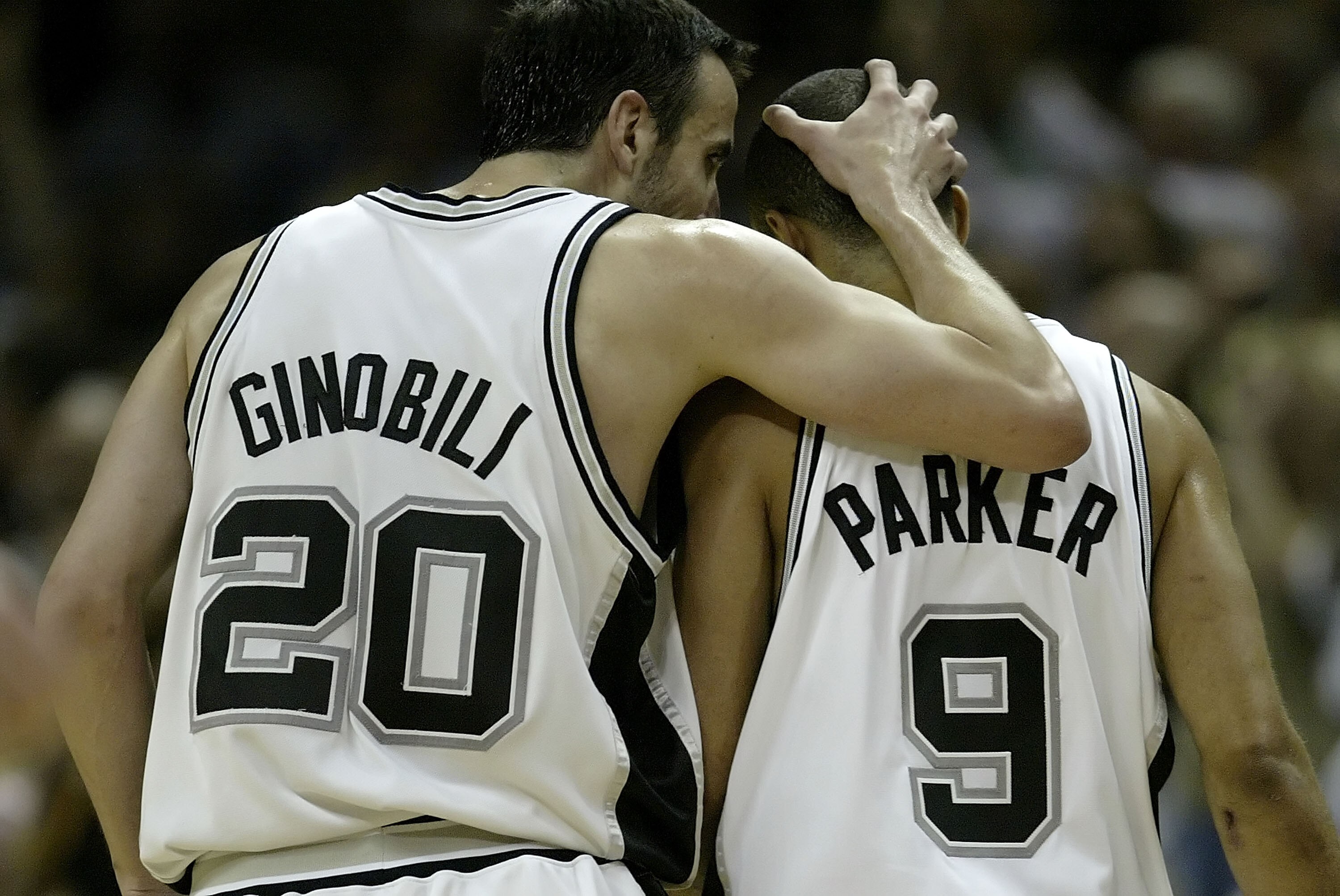 SAN ANTONIO - MAY 22:  Manu Ginobili #20 of the San Antonio Spurs puts his arm around teammate Tony Parker #9 in the third quarter against the Utah Jazz in Game Two of the Western Conference Finals during the 2007 NBA Playoffs at AT&T Center on May 22, 20