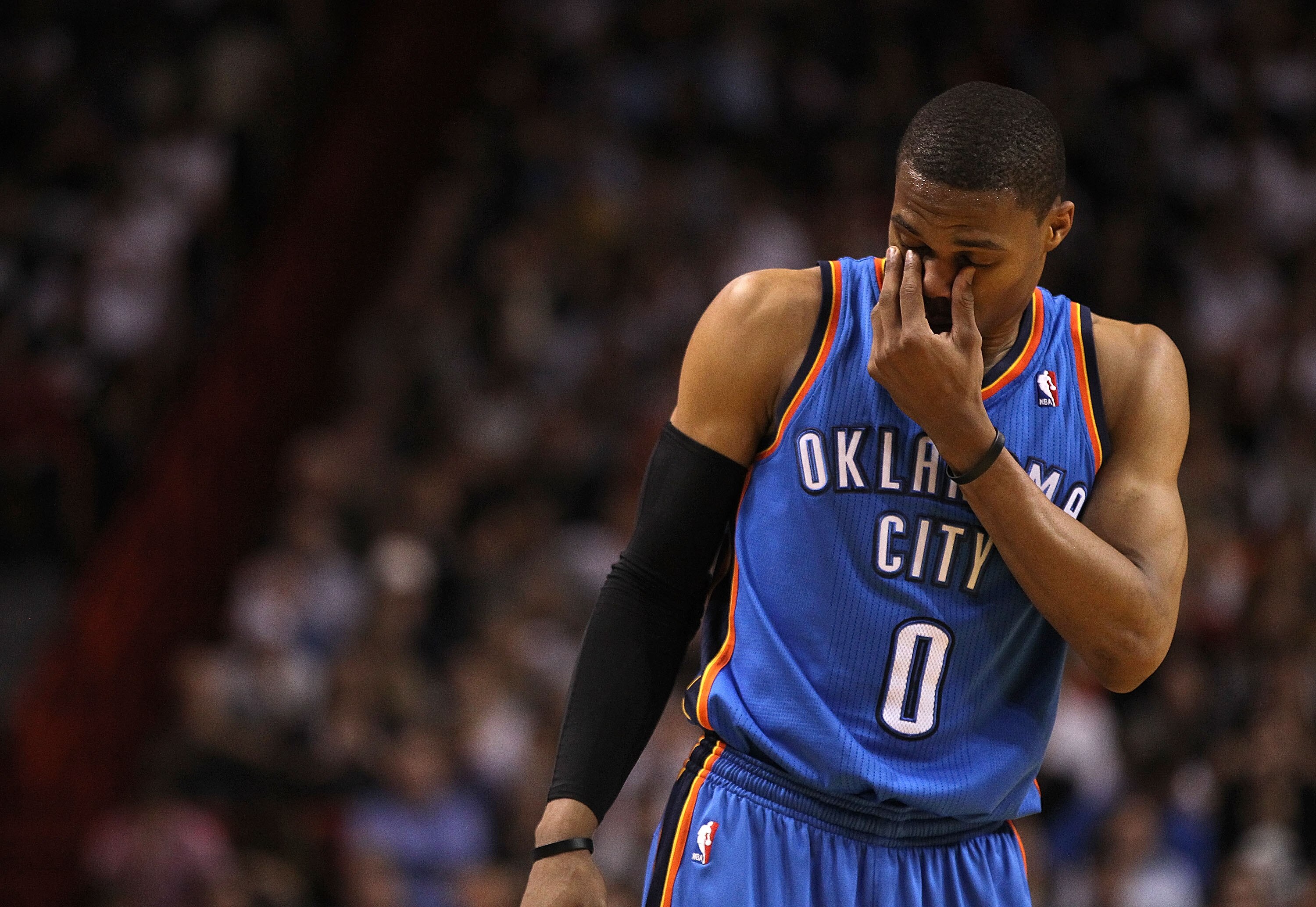 MIAMI, FL - MARCH 16:  Russell Westbrook #0 of the Oklahoma City Thunder rubs his eyes during a game against the Miami Heat at American Airlines Arena on March 16, 2011 in Miami, Florida. NOTE TO USER: User expressly acknowledges and agrees that, by downl