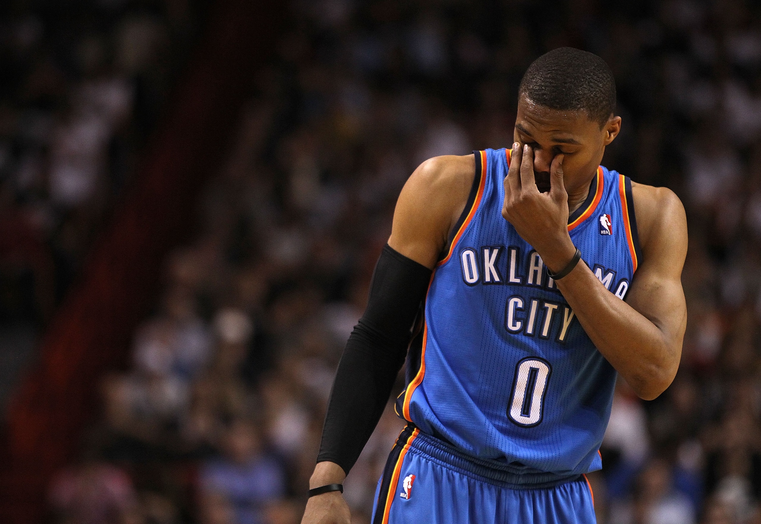 MIAMI, FL - MARCH 16:  Russell Westbrook #0 of the Oklahoma City Thunder rubs his eyes during a game against the Miami Heat at American Airlines Arena on March 16, 2011 in Miami, Florida. NOTE TO USER: User expressly acknowledges and agrees that, by downl