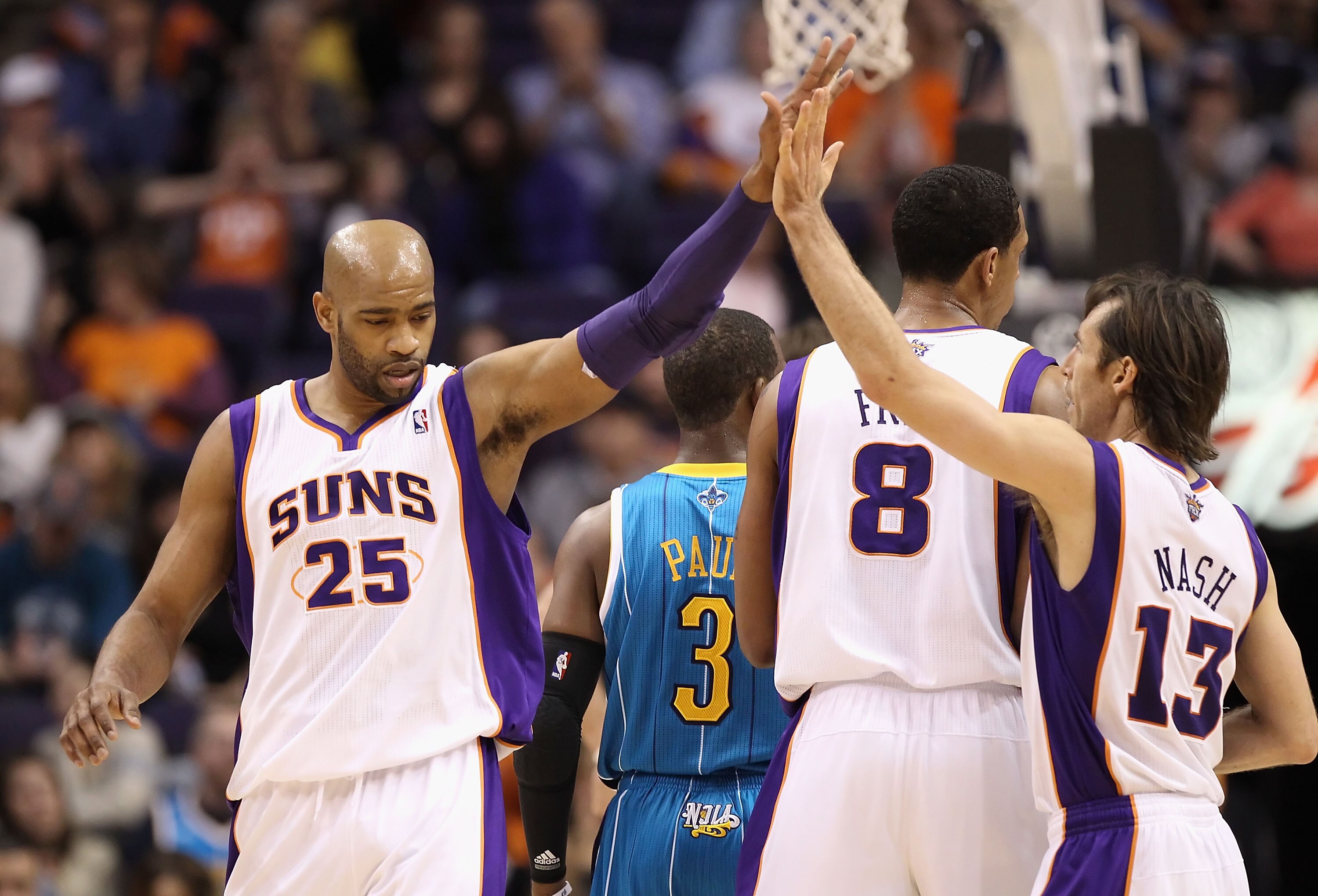 PHOENIX, AZ - JANUARY 30:  Vince Carter #25 of the Phoenix Suns high fives teammate Steve Nash #13 after scoring against the New Orleans Hornets during the NBA game at US Airways Center on January 30, 2011 in Phoenix, Arizona.  The Suns defeated the Horne