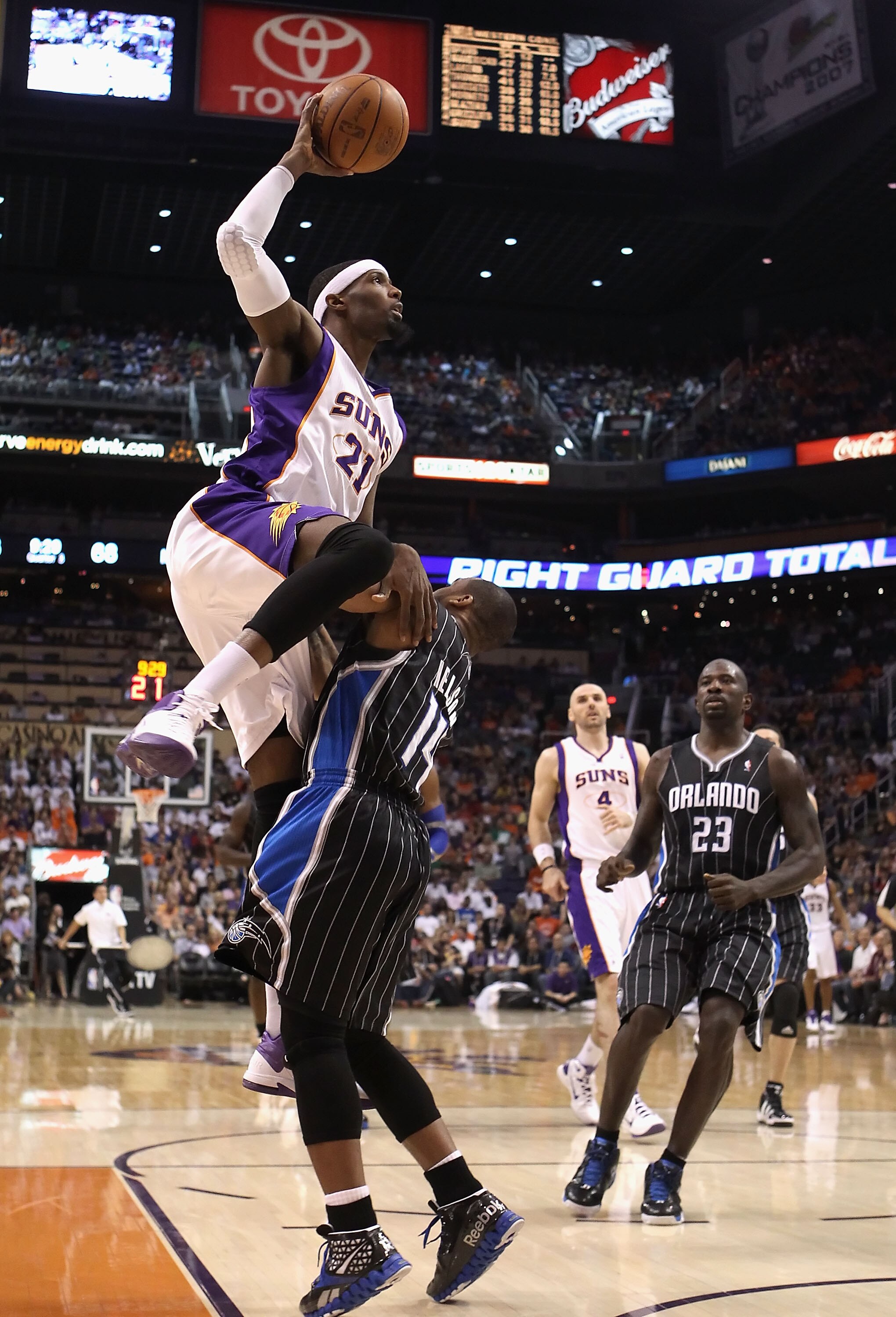 PHOENIX, AZ - MARCH 13:  Hakim Warrick #21 of the Phoenix Suns puts up a shot over Jameer Nelson #14 of the Orlando Magic during the NBA game at US Airways Center on March 13, 2011 in Phoenix, Arizona. The Magic defeated the Suns 111-88.  NOTE TO USER: Us