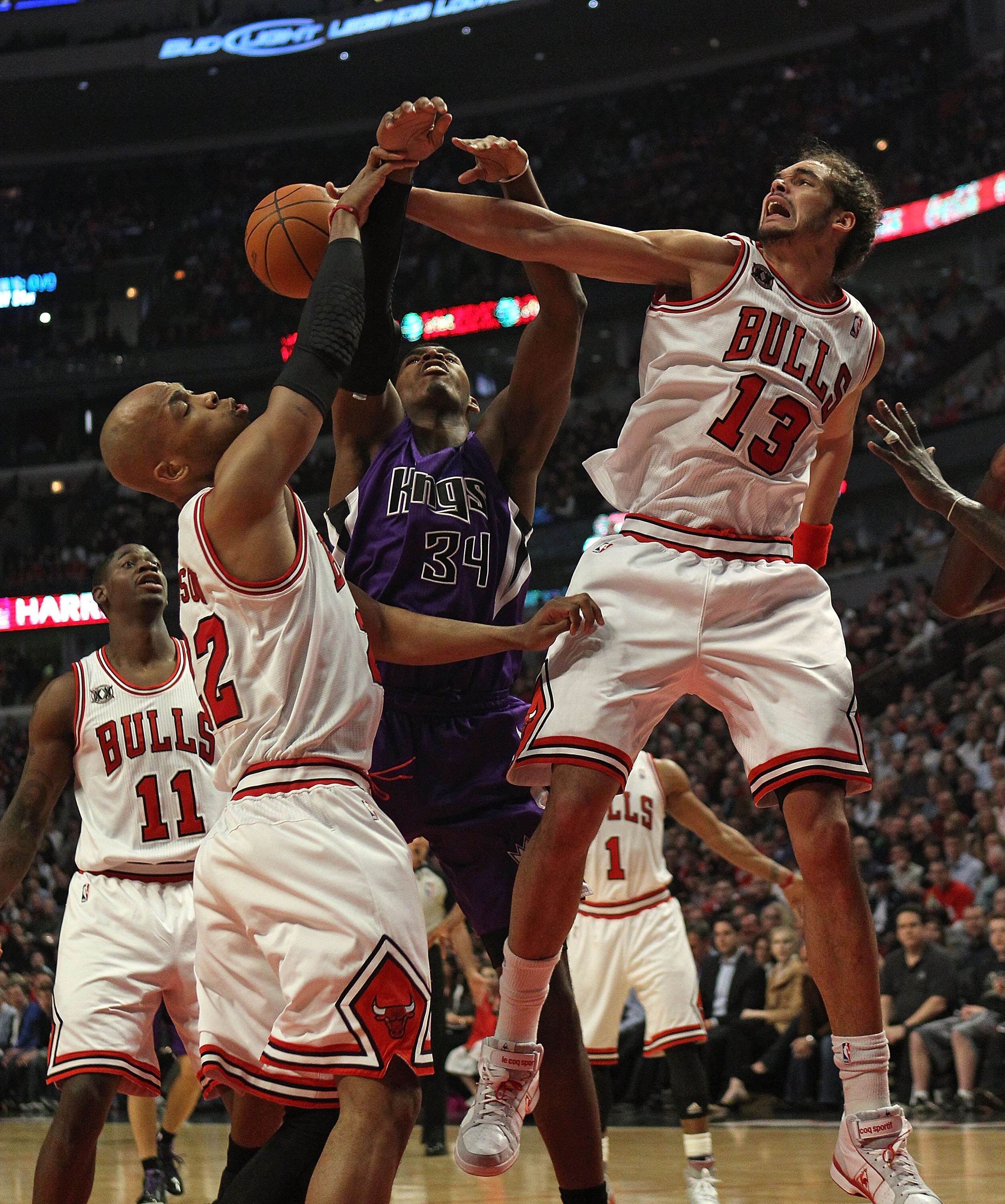 CHICAGO, IL - MARCH 21: Joakim Noah #13 of the Chicago Bulls blocks a shot by Jason Thompson #34 of the Sacramento Kings as teammate Taj Gibson #22 also defends at the United Center on March 21, 2011 in Chicago, Illinois. NOTE TO USER: User expressly ackn