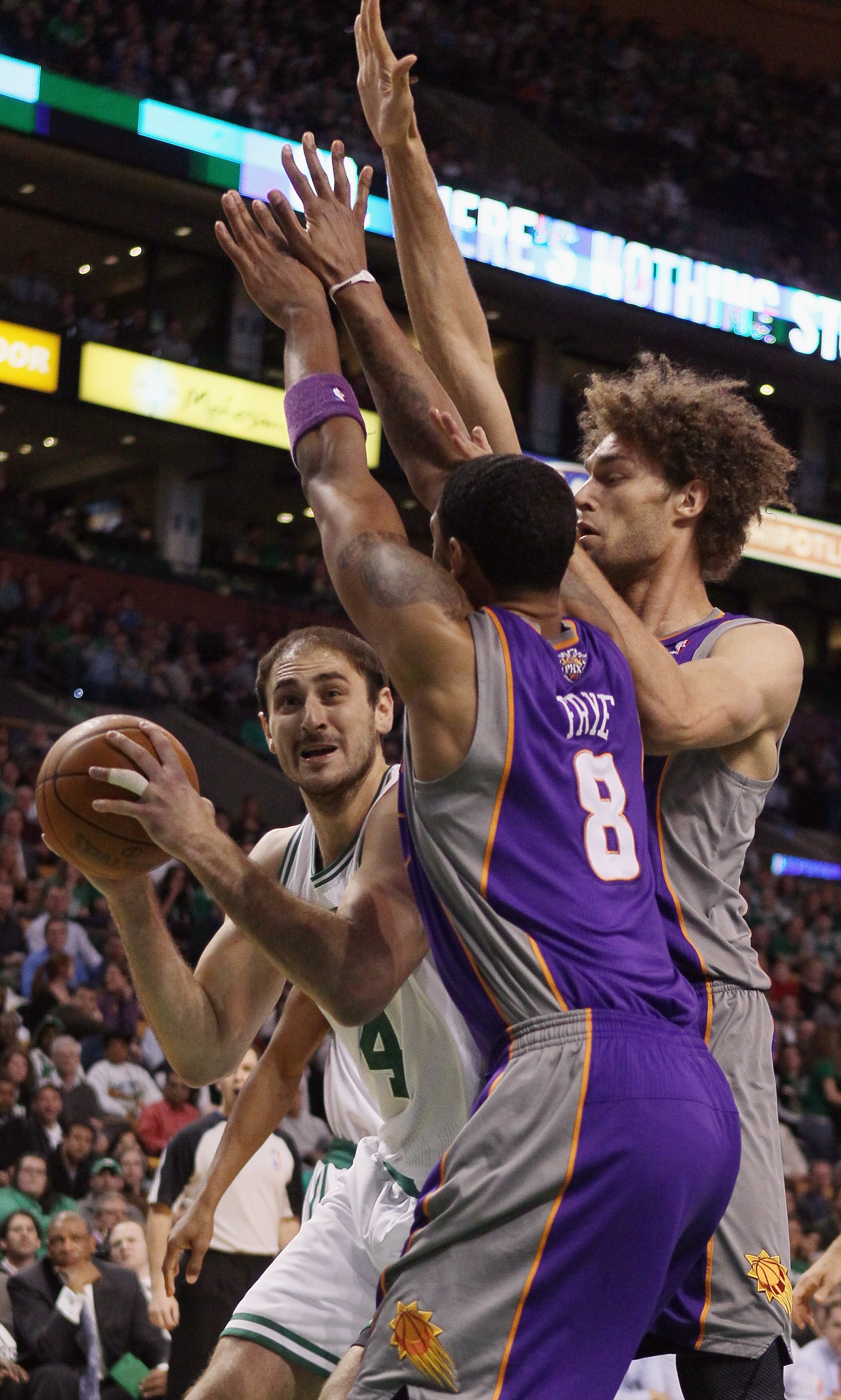 BOSTON, MA - MARCH 02:  Nenad Krstic #4 of the Boston Celtics tries to shoot as Channing Frye #8 and Robin Lopez #15 of the Phoenix Suns defend on March 2, 2011 at the TD Garden in Boston, Massachusetts.  NOTE TO USER: User expressly acknowledges and agre
