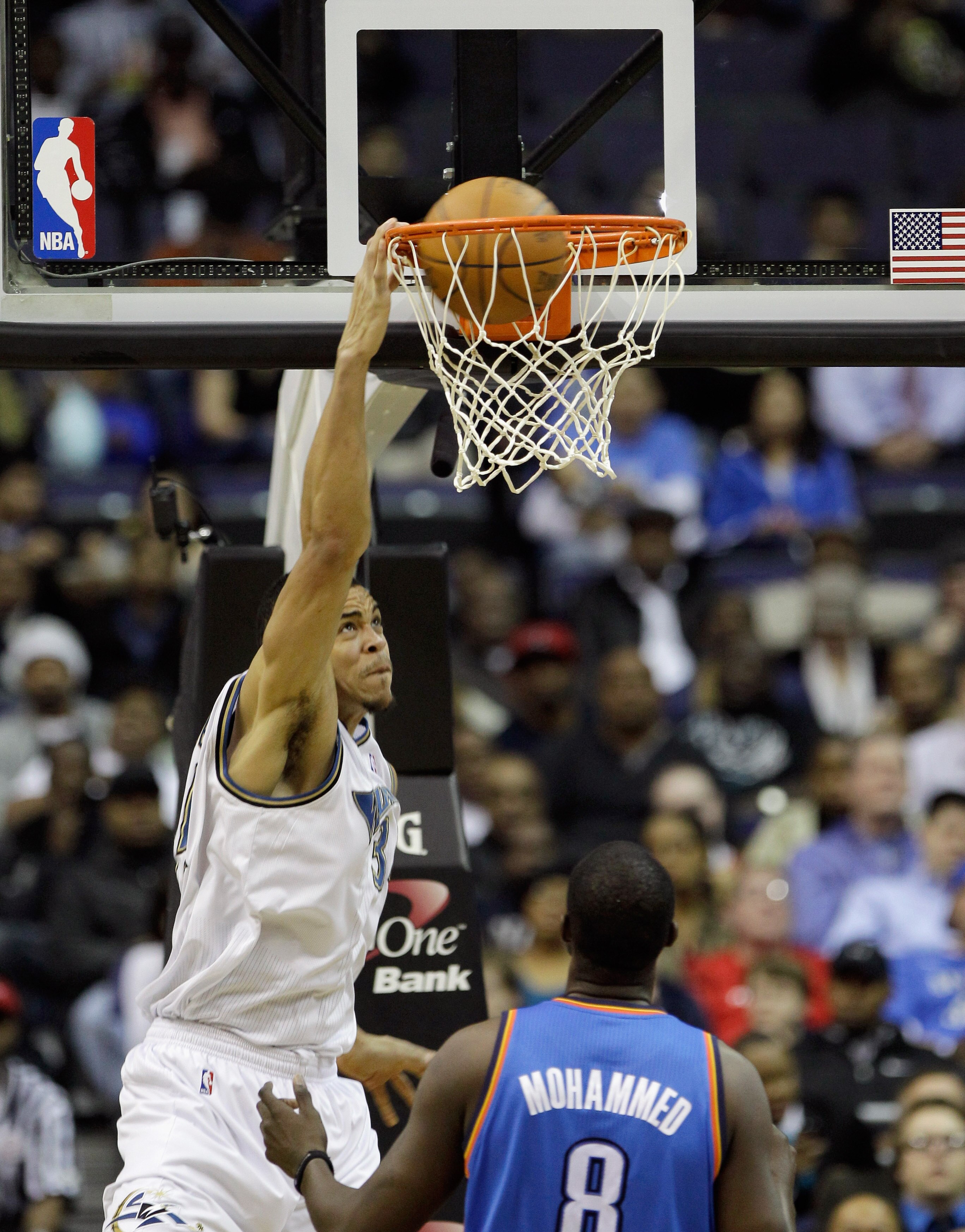 WASHINGTON, DC - MARCH 14:  JaVale McGee #34 of the Washington Wizards dunks against Nazr Mohammed #8 of the Oklahoma City ThundeOklahoma City Thunderduring the first half at the Verizon Center on March 14, 2011 in Washington, DC. NOTE TO USER: User expre