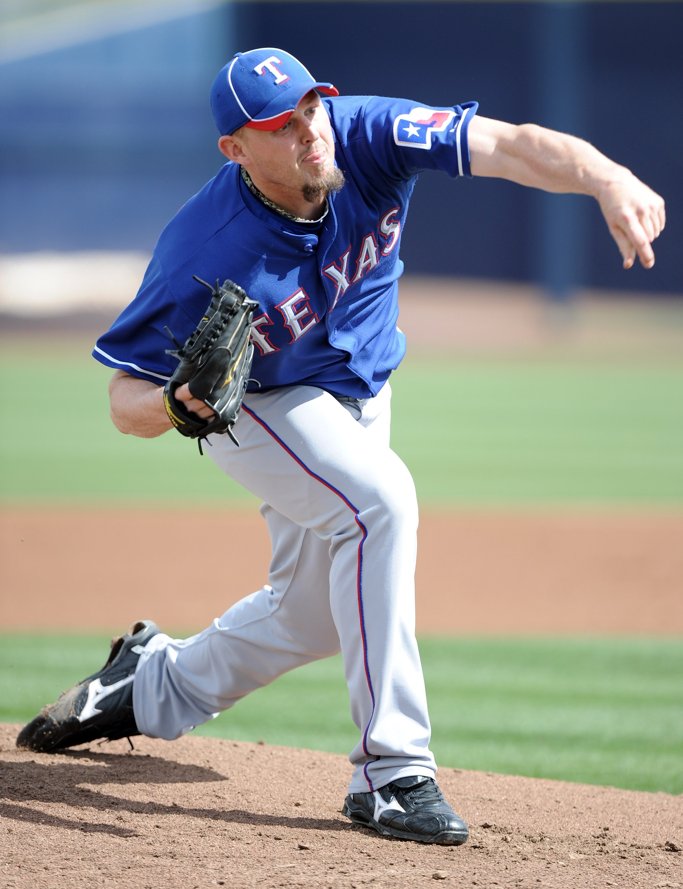 PEORIA, AZ - MARCH 01:  Matt Harrison #54 of the Texas Rangers pitches against the Seattle Mariners in the first inning during spring training at Peoria Stadium on March 1, 2011 in Peoria, Arizona.  (Photo by Harry How/Getty Images)