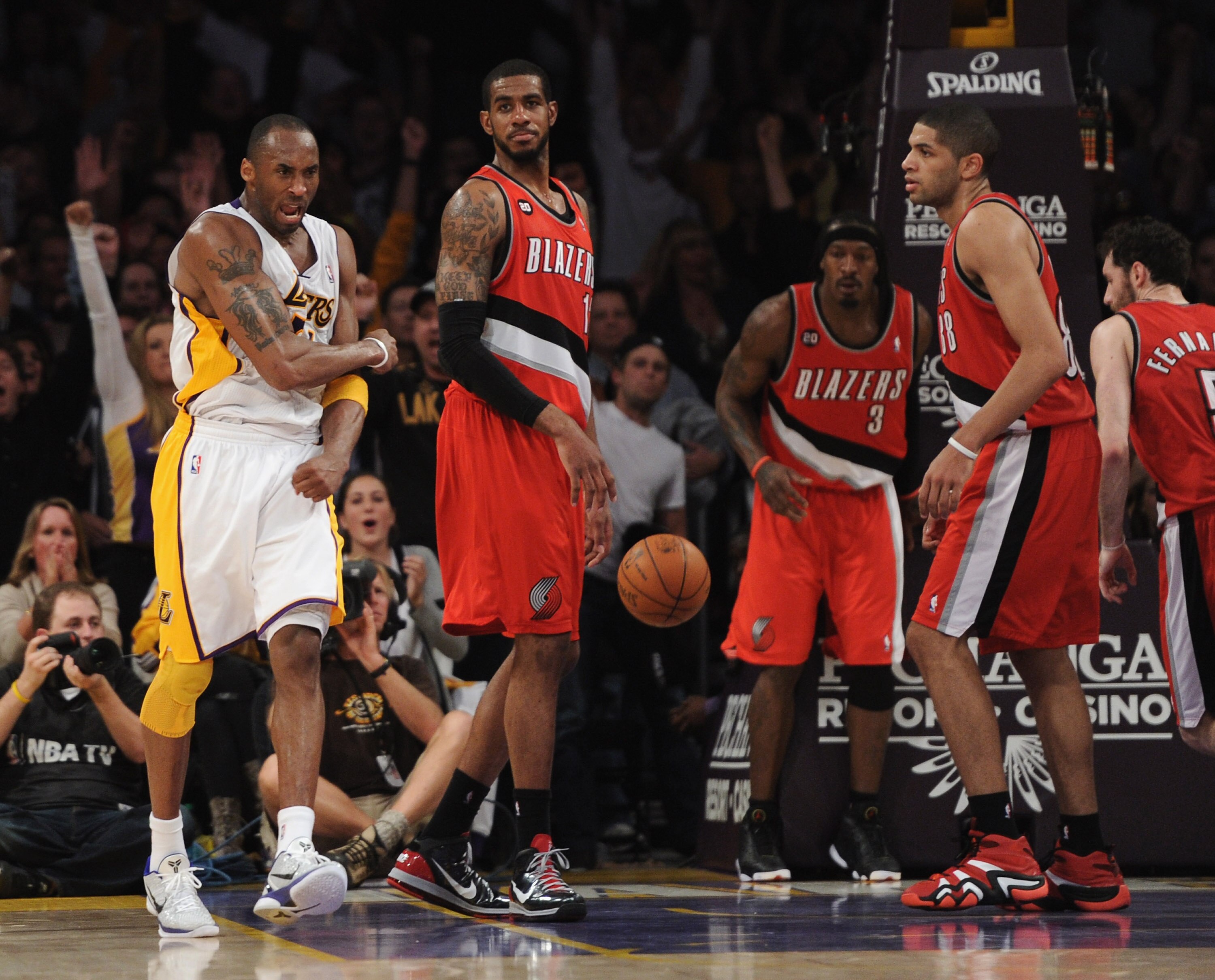 LOS ANGELES, CA - MARCH 20:  Kobe Bryant #24 of the Los Angeles Lakers celebrates his basket in the last few minutes of play in front of LaMarcus Aldridge #12 and Nicolas Batum #88 of the  Portland Trail Blazers at the Staples Center on March 20, 2011 in