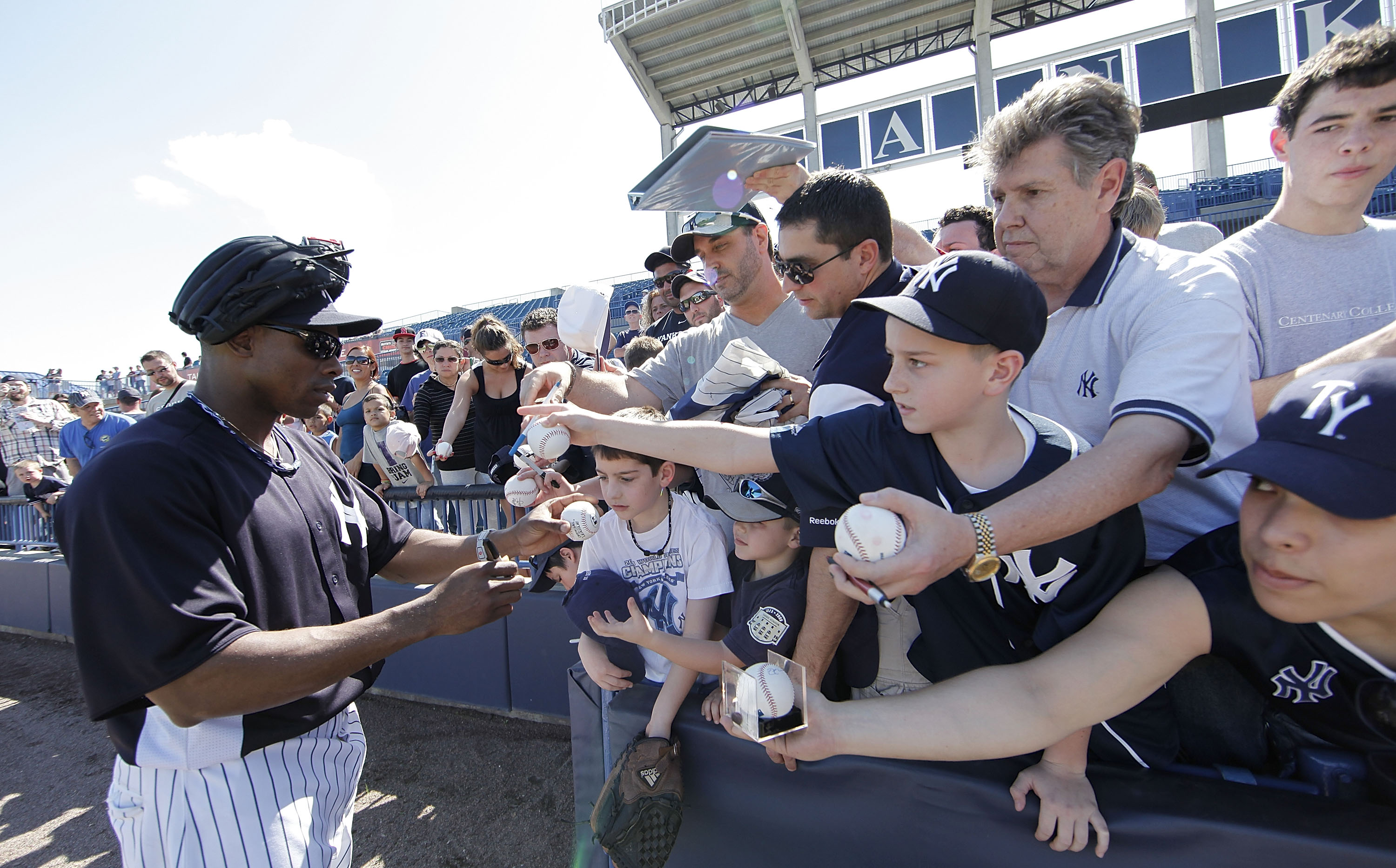 TAMPA, FL - FEBRUARY 21: Curtis Granderson #14 of the New York Yankees signs autographs for fans during the second day of full teams workouts at Spring Training on February 21, 2011 at the George M. Steinbrenner Field in Tampa, Florida.  (Photo by Leon Ha
