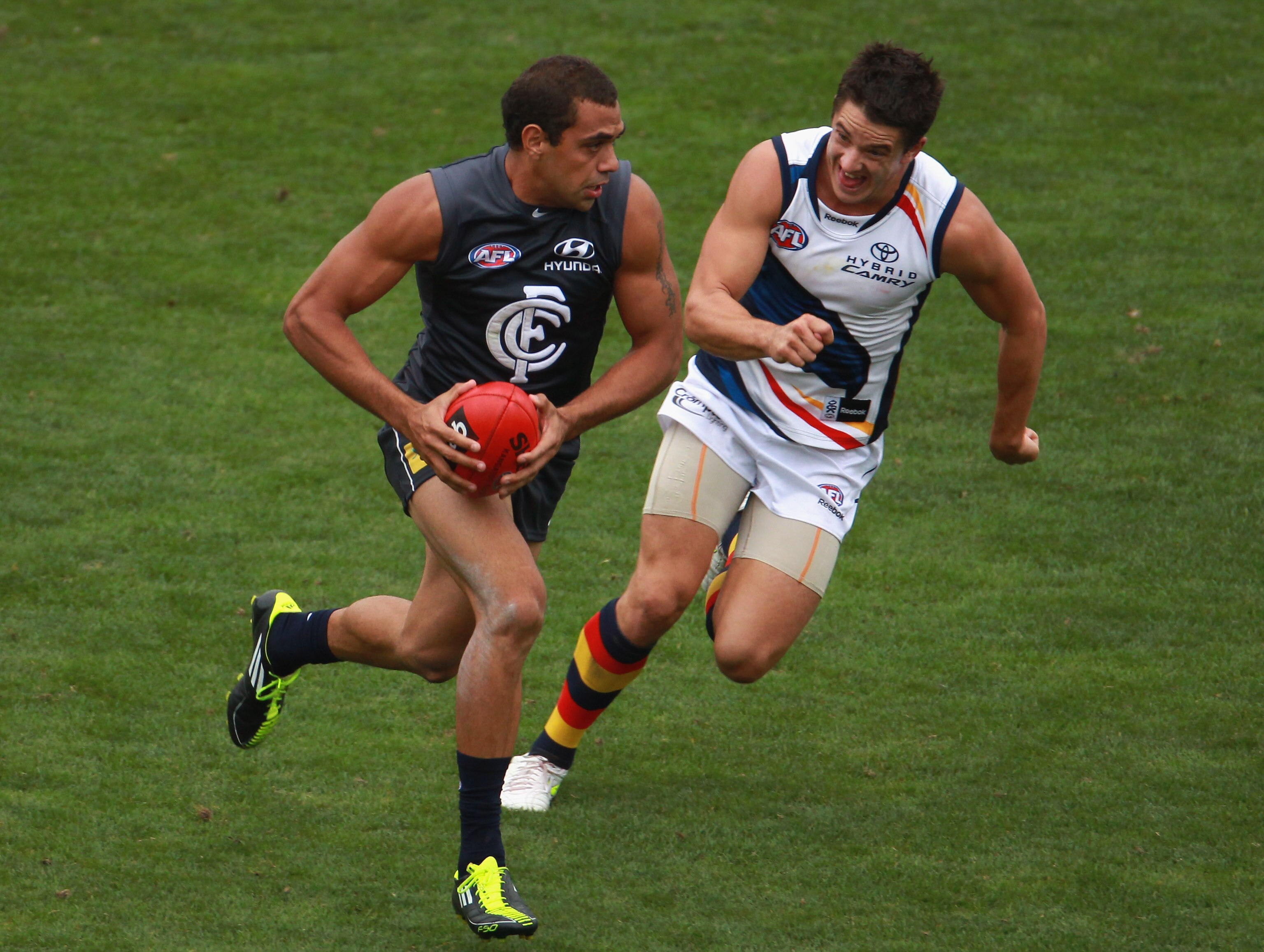 MELBOURNE, AUSTRALIA - MARCH 04: Chris Yarran of the Blues runs from his opponent during the NAB Challenge AFL match between the Carlton Blues and the Adelaide Crows at Visy Park on March 4, 2011 in Melbourne, Australia.  (Photo by Robert Cianflone/Getty
