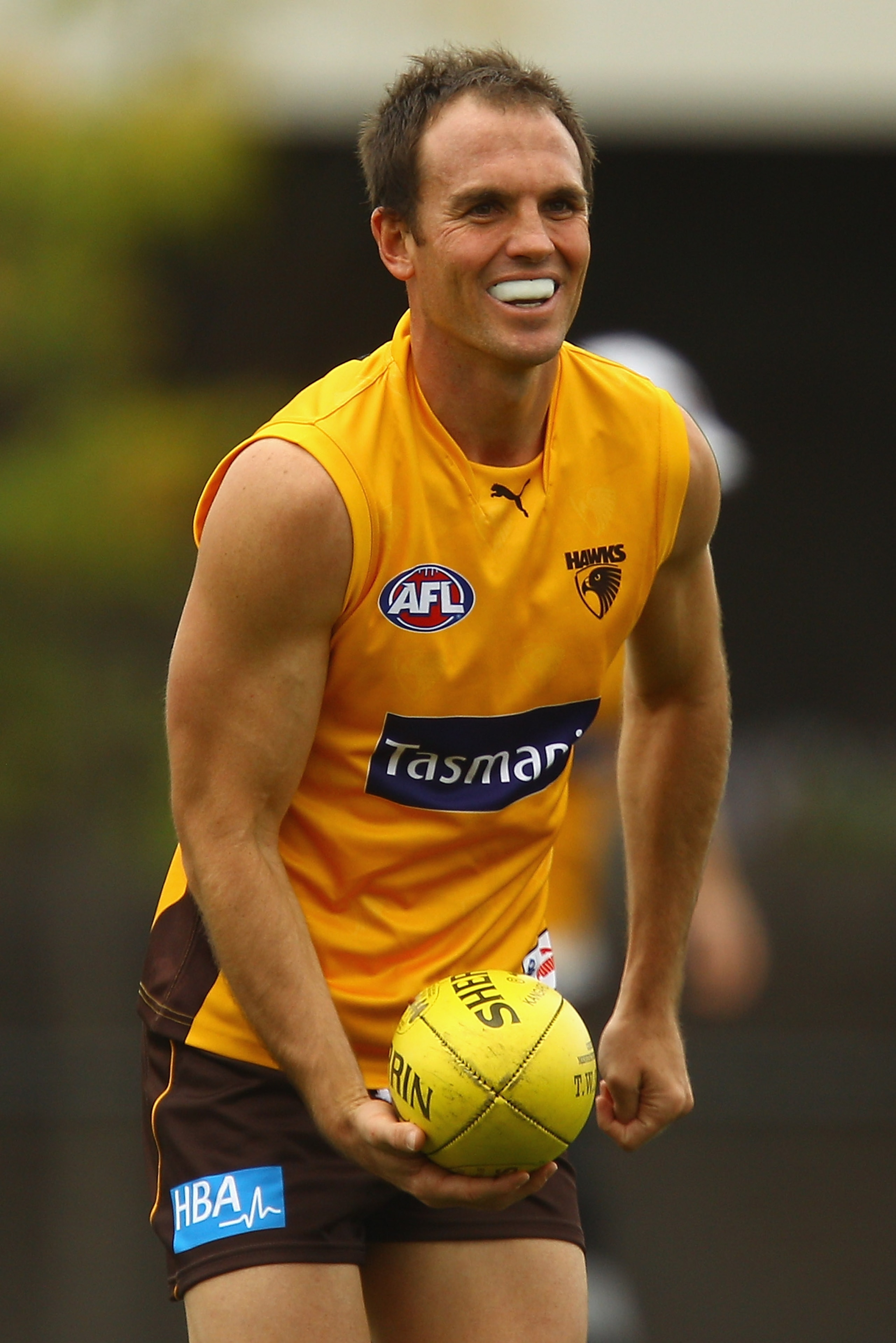 MELBOURNE, AUSTRALIA - MARCH 18:  Cameron Bruce of the Hawks looks to handball the ball during a Hawthorn Hawks AFL training session at Waverley Park on March 18, 2011 in Melbourne, Australia.  (Photo by Quinn Rooney/Getty Images)
