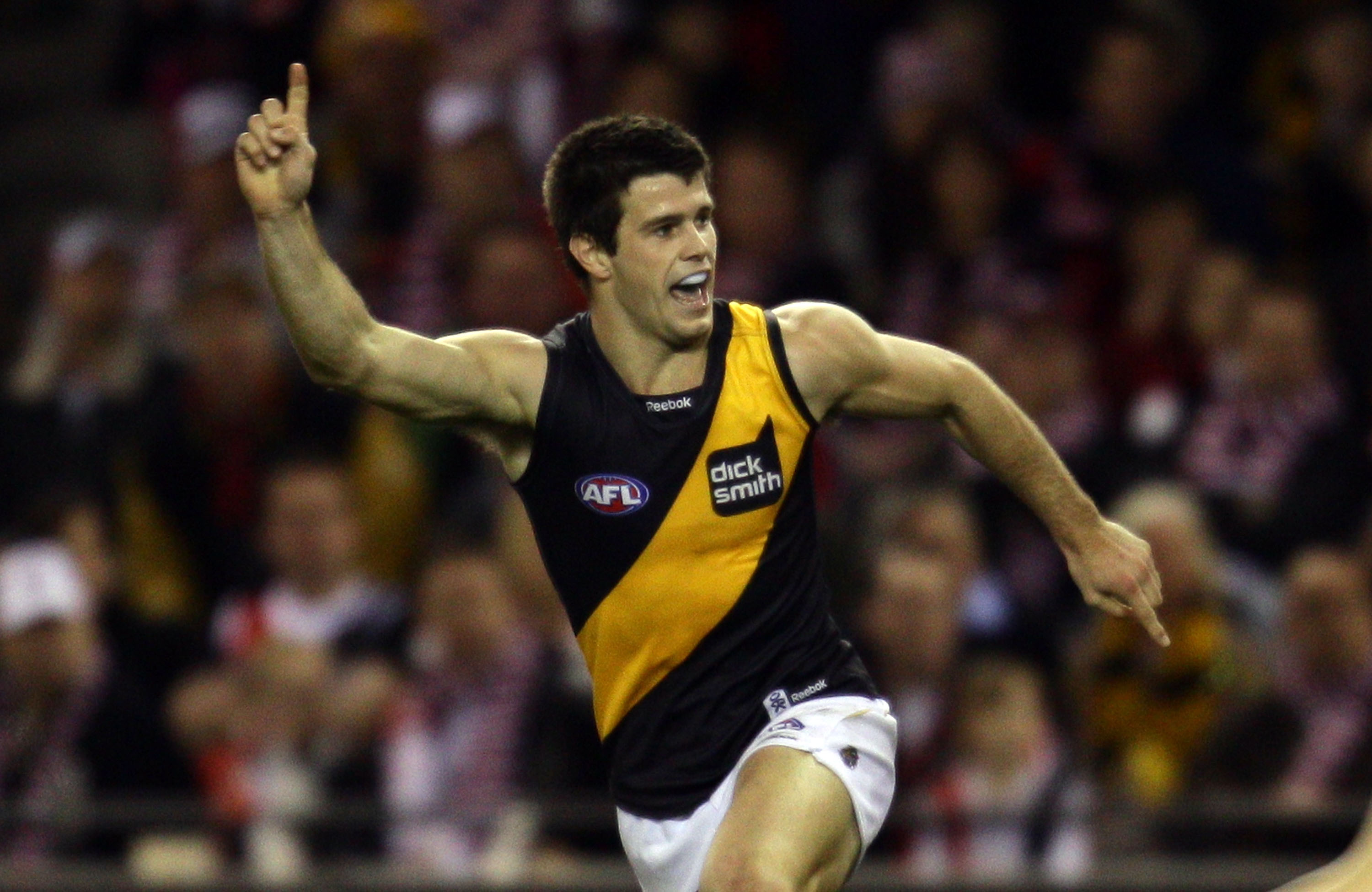 MELBOURNE, AUSTRALIA - AUGUST 21:  Trent Cotchin of the Tigers celebrates after kicking a goal during the round 21 AFL match between the St Kilda Saints and the Richmond Tigers at Etihad Stadium on August 21, 2010 in Melbourne, Australia.  (Photo by Scott